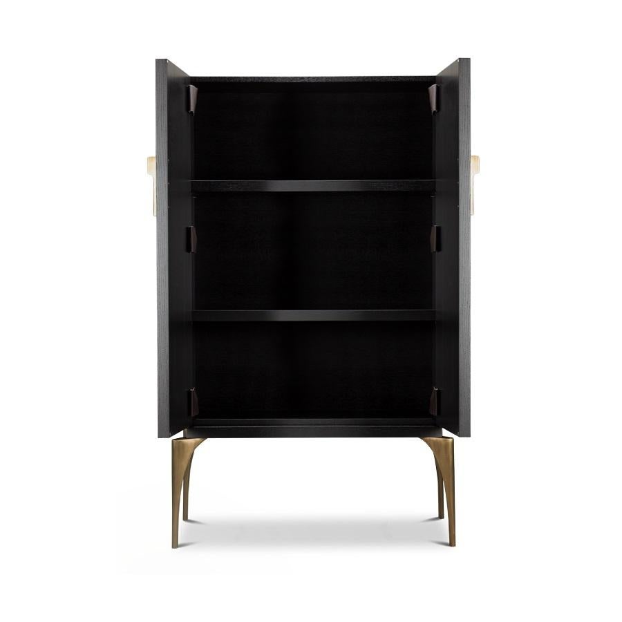 This cabinet brings a dazzling golden touch to your space. This storage cabinet in Espresso finish oak veneer has layered brass door facades and cast brass legs and handles.
Mirrored interiors with light inside the cabinet.
Other finishes and