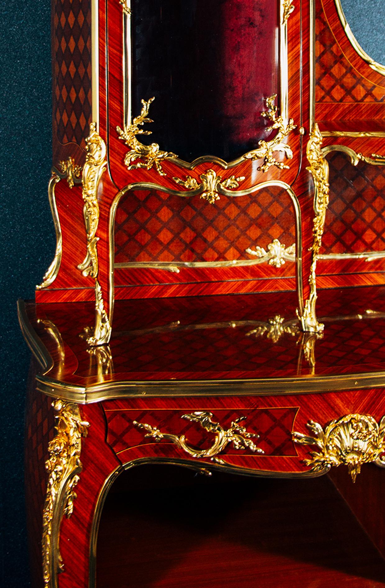 A Louis XV style gilt bronze mounted parquetry vitrine cabinet.