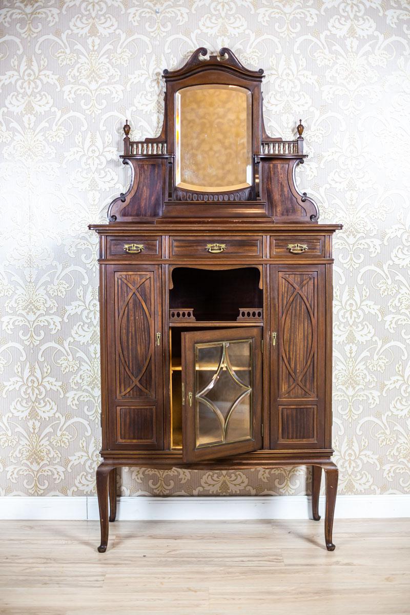 We present you a piece of furniture made of mahogany wood and veneer.
All is from the turn of the 19th and 20th centuries.
The cabinet is composed of a base on high legs and an add-on unit in the form of a wall with a mirror and a small