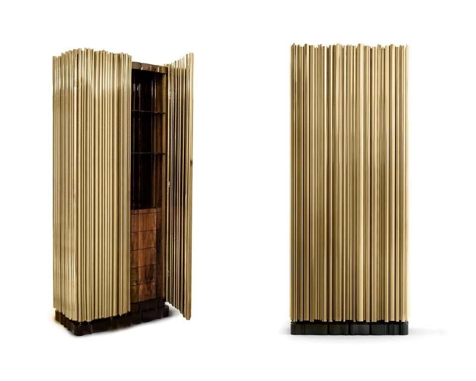 Cabinet in gold-plated brass
Rosewood veneer, black
lacquer, gold-plated brass and glass.
Estimated production time: 14-15 weeks
Measures: Height 79.53 in. (202 cm)
Width 33.47 in. (85 cm)
Depth 17.72 in. (45 cm).

The Cabinet is inspired by the