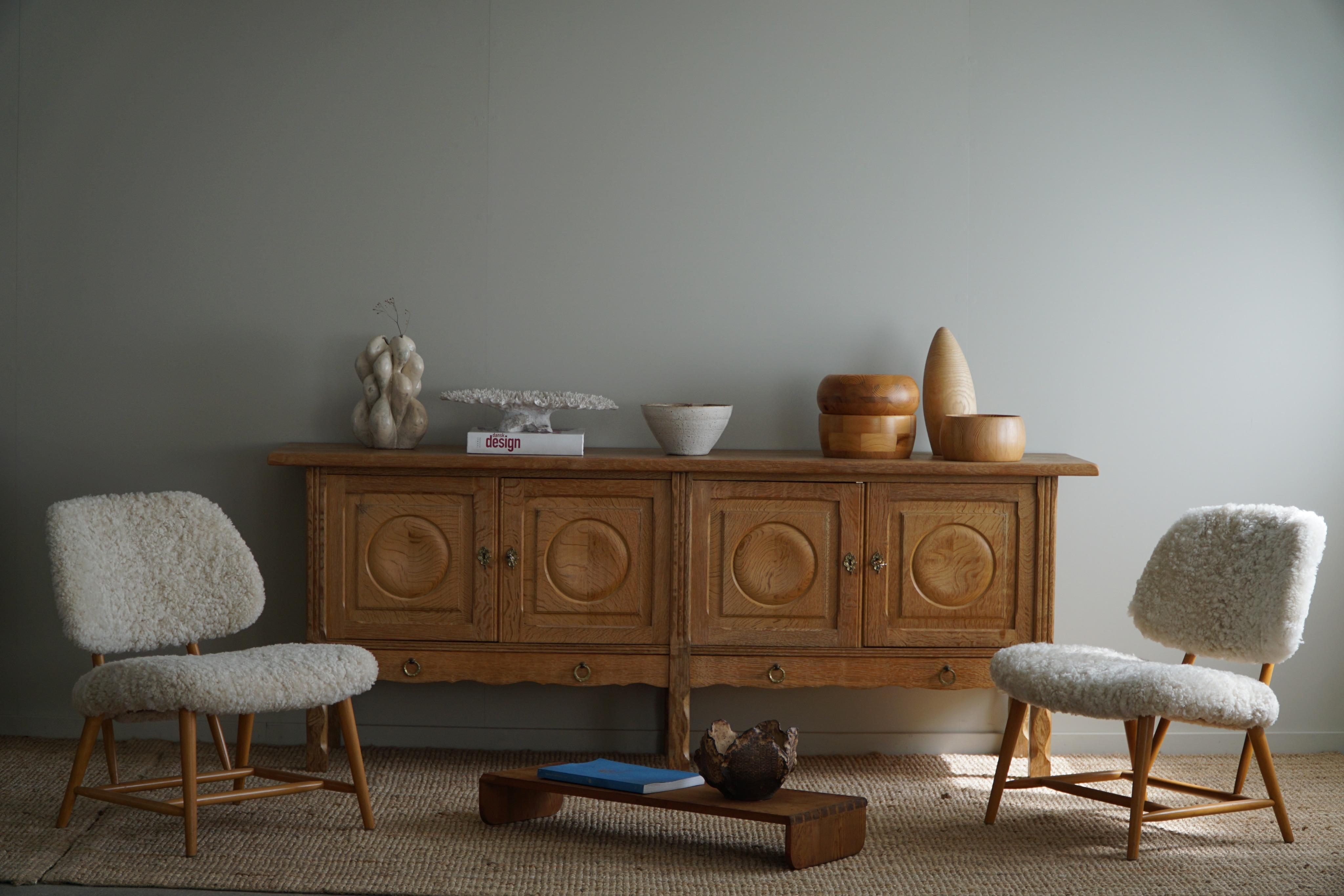 Fantastic low Classic sideboard in solid oak. Made by a Danish Cabinetmaker, Anker Sørensen in 1960s. This piece is in a good vintage condition, with some signs of wear on the top surface.

This brutalist object will fit into many interior styles.
