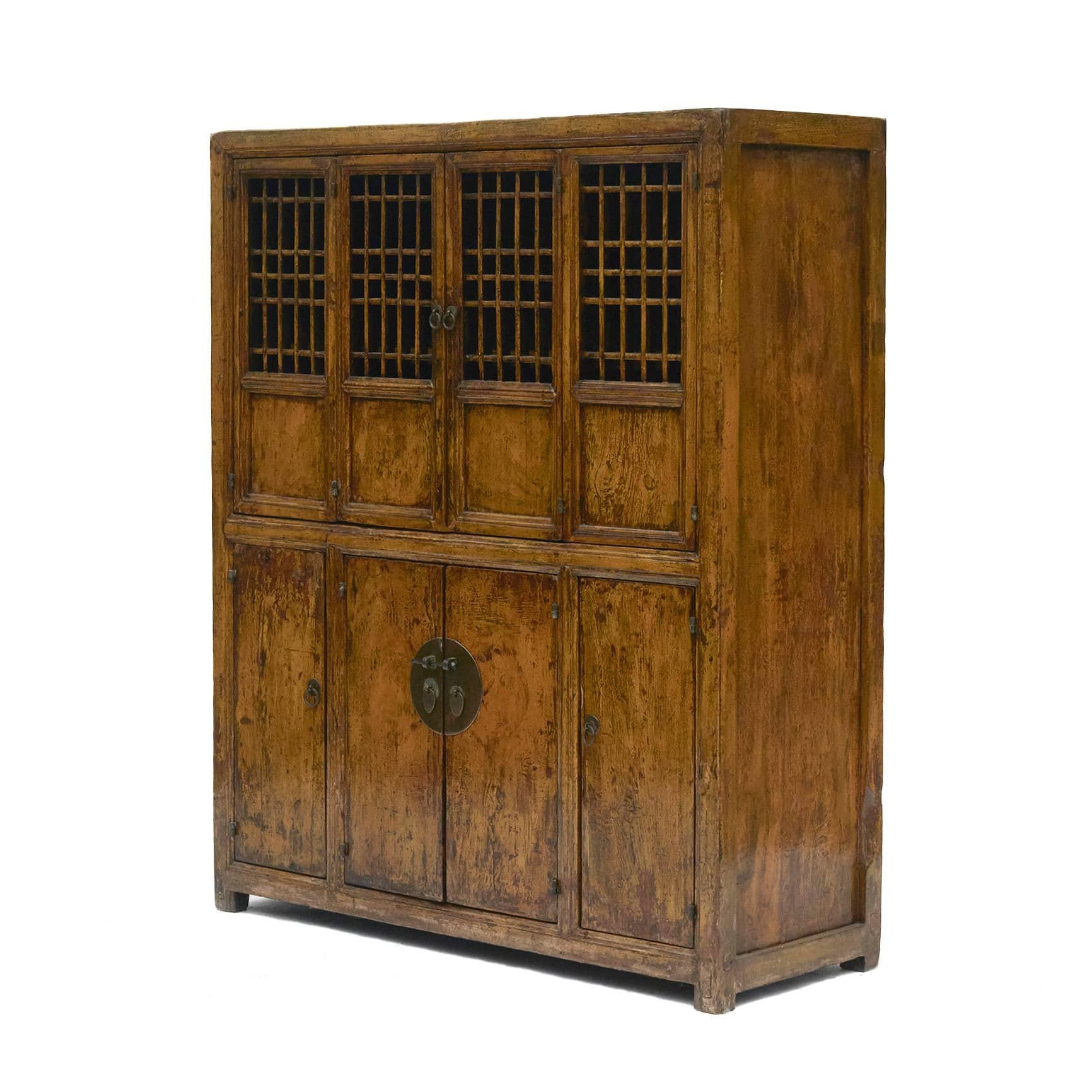 Cabinet in original dark yellow lacquer with beautiful age-related patina.

The top a pair of doors with bars, opens up double, bottom with four doors.

Original cabinet with patina highlighted by a clear lacquer surface finish.

Shandong