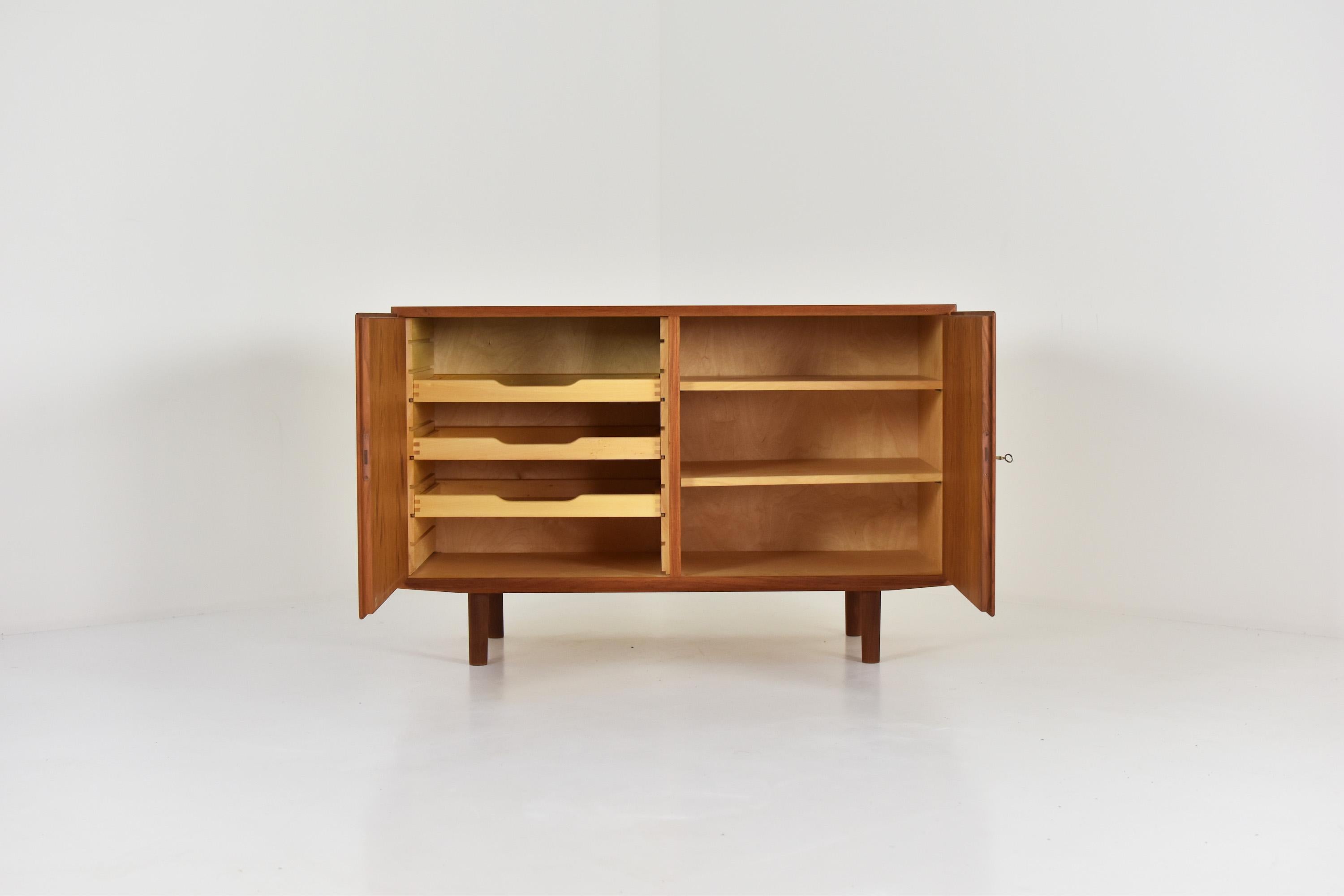 Cabinet in teak by Poul Hundevad for Hundevad & Co, Denmark, 1950s. This cabinet features two sections covering shelves and drawers. Restored with love. Labeled.