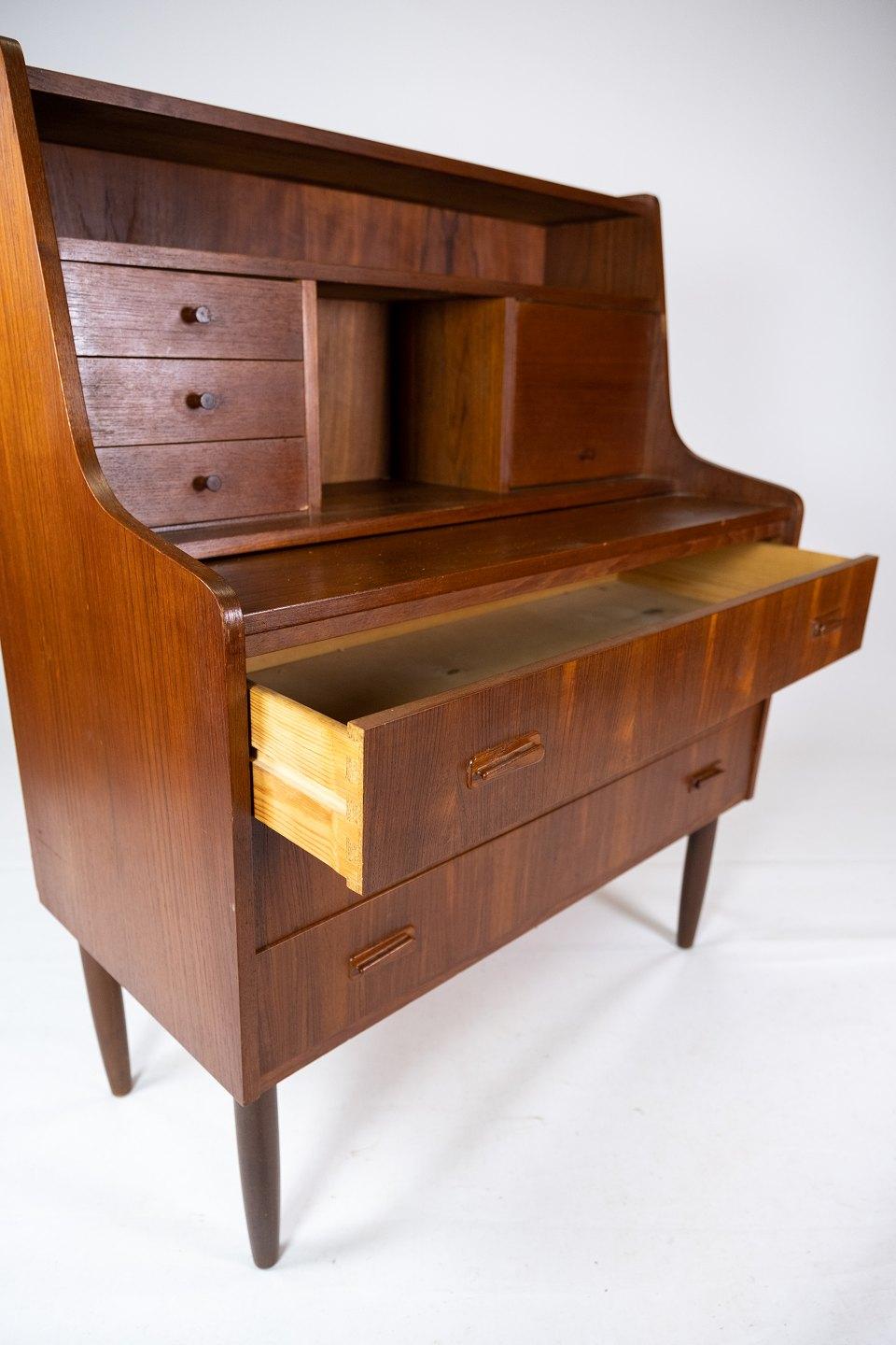 This secretary, designed and produced in Denmark around the 1960s, is a beautiful example of Danish furniture art from this era. Made of teak wood, the secretary exudes a warm and natural elegance.

With its distinctive design and fine