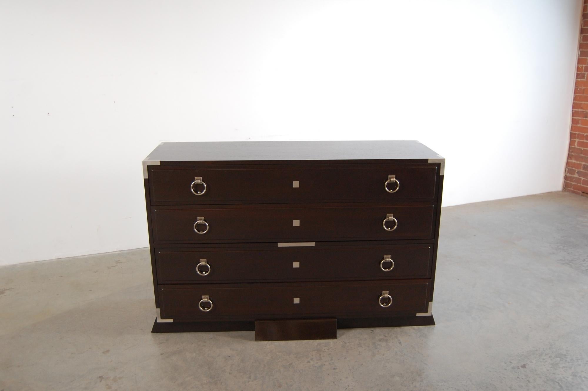 Very elegant four drawer cabinet, in the manner of Dominique. Constructed of Mahogany, with inlaid metal details, and beautifully crafted hardware. Cabinet measures 55 1/2