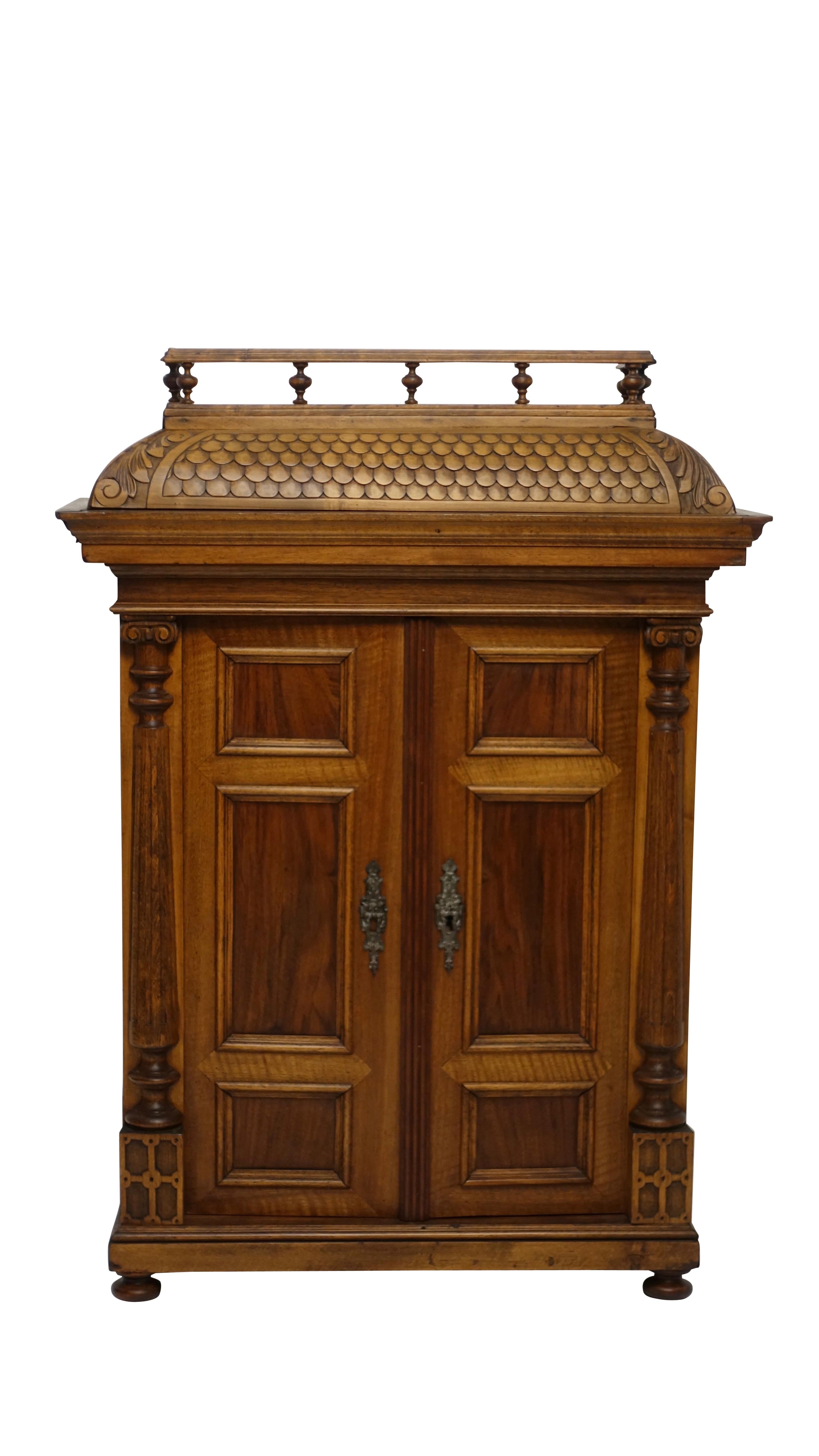 Wonderful cabinet maker's scale model of a walnut armoire with elaborate detailing of a miniature baluster railing around the mansard style top. Having fluted columns on plinth bases flanking a pair of recessed panelled doors that open to fitted