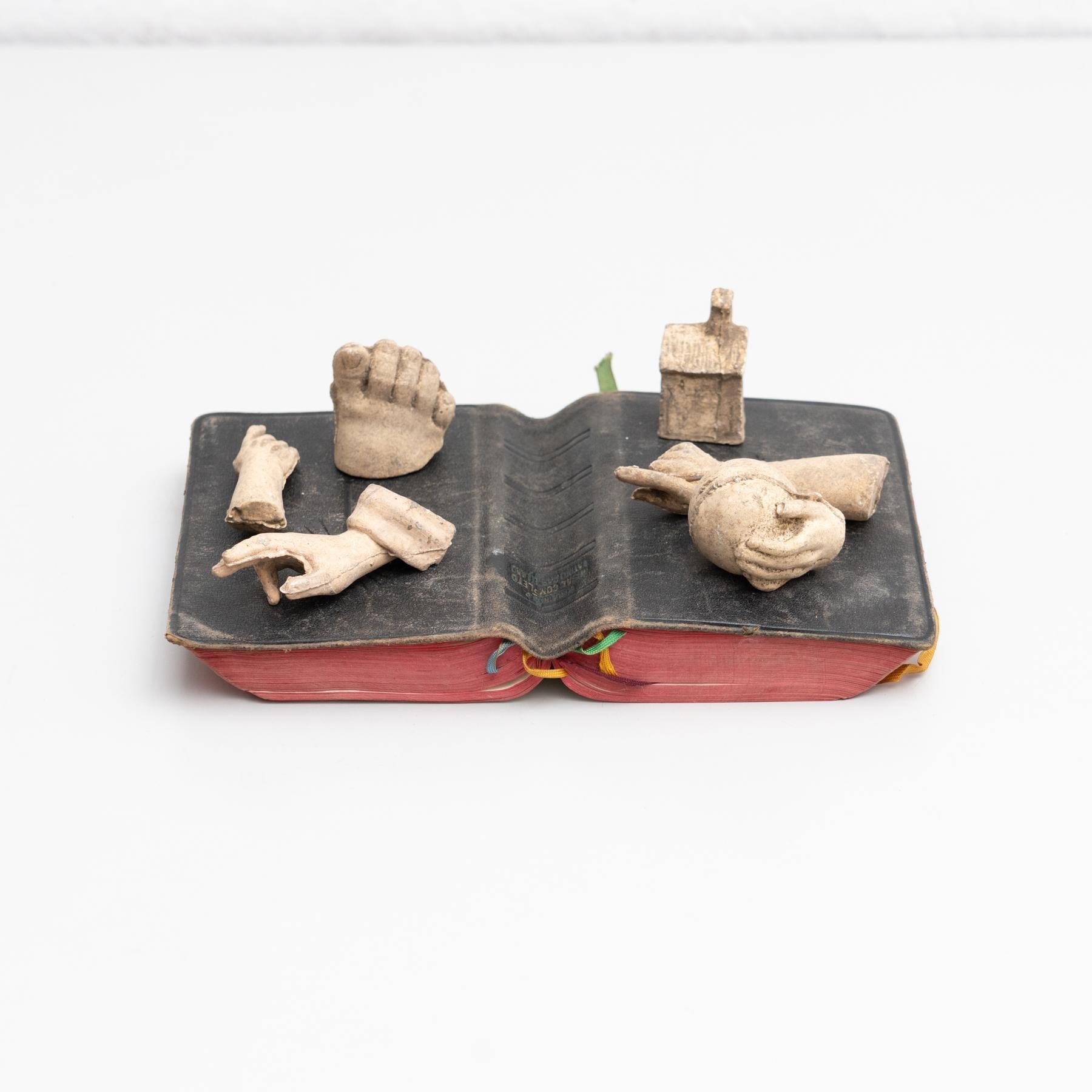 Discover the enchanting allure of this Cabinet of Curiosities, a unique antique book and plaster sculptural artwork created circa 1950. This captivating piece, crafted by an unknown artist, combines a selection of plaster sculptural parts arranged