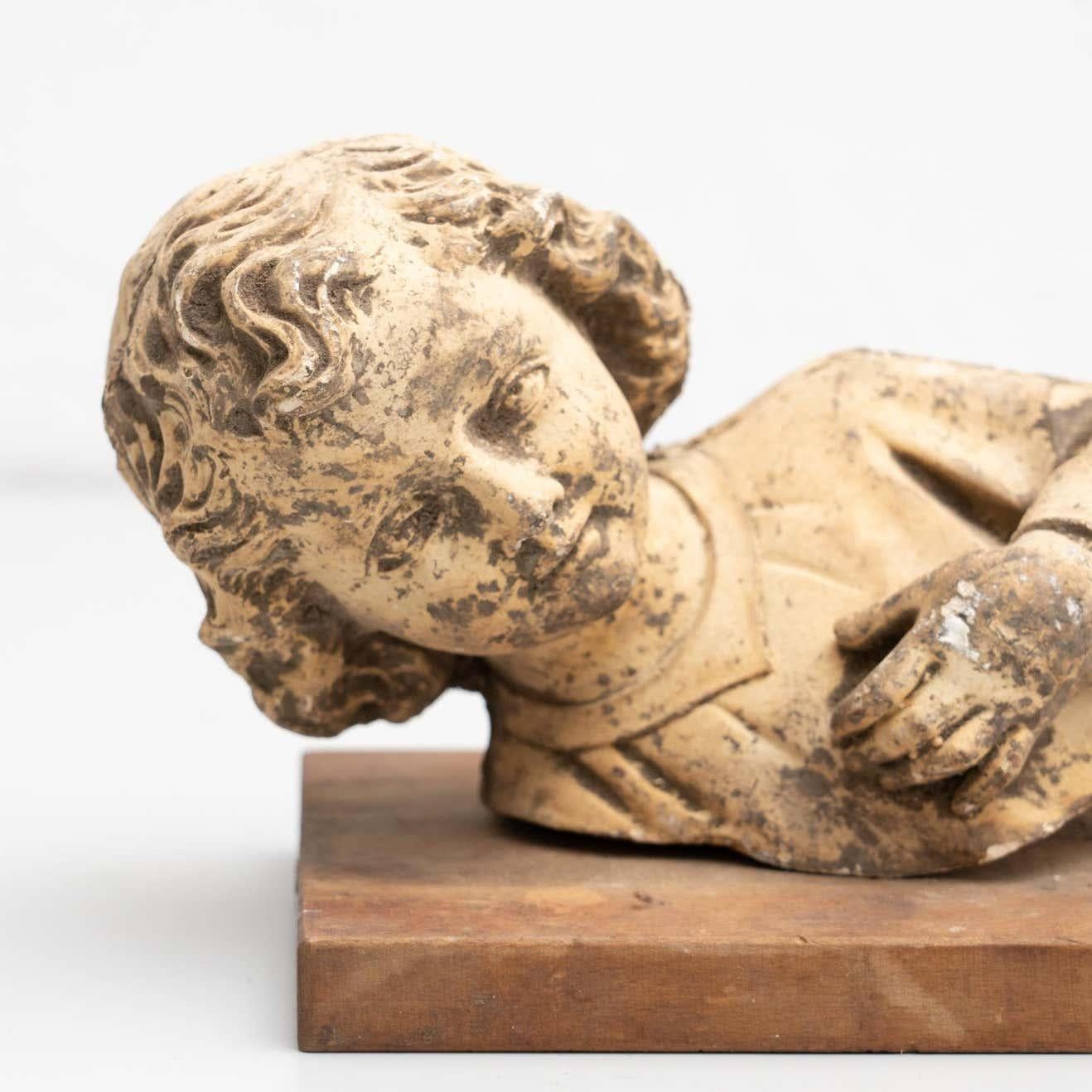 Cabinet of curiosities of plaster baby Jesus on a wooden stand.  Made in traditional Catalan atelier in Olot, Spain, circa 1950.  Olot has a long tradition in the production of sculptures and religious imagery. The art and industry of religious
