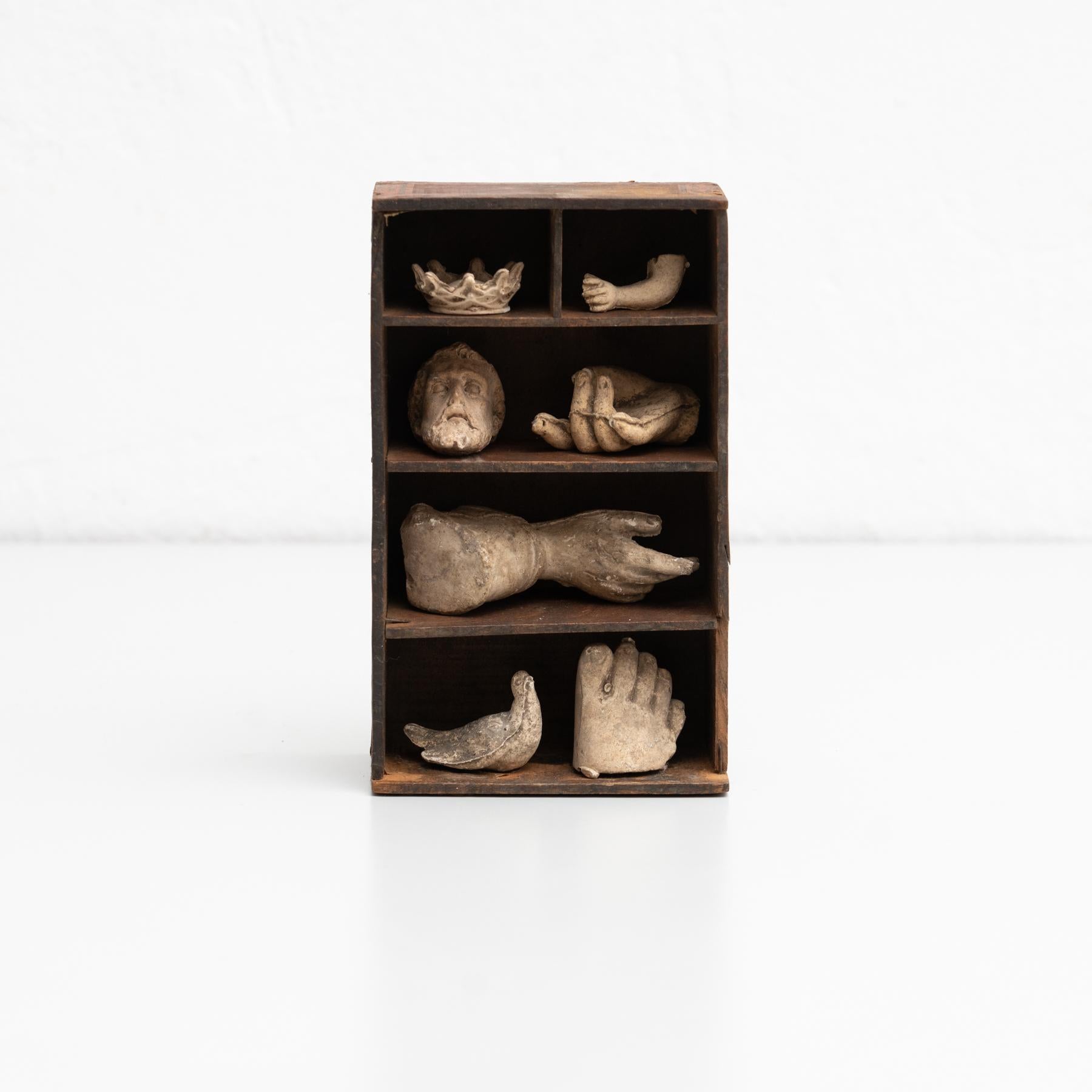 Cabinet of curiosities of plaster figures and pieces in a wooden cabinet.

Made in traditional Catalan atelier in Olot, Spain, circa 1950.

Olot has a long tradition in the production of sculptures and religious imagery. The art and industry of