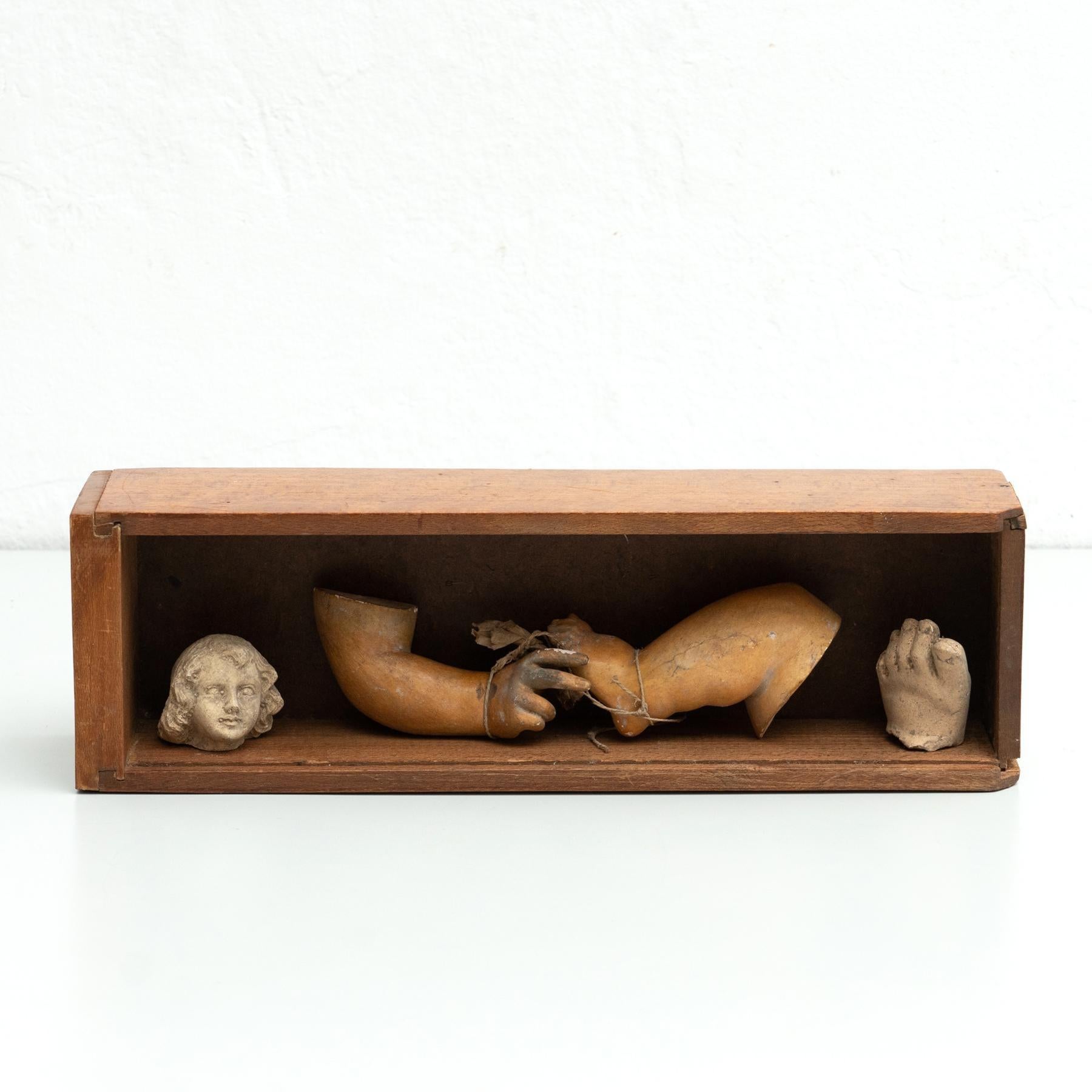 Cabinet of curiosities of plaster figures and pieces in a wooden drawer.    Made in traditional Catalan atelier in Olot, Spain, circa 1950.    Olot has a long tradition in the production of sculptures and religious imagery. The art and industry of