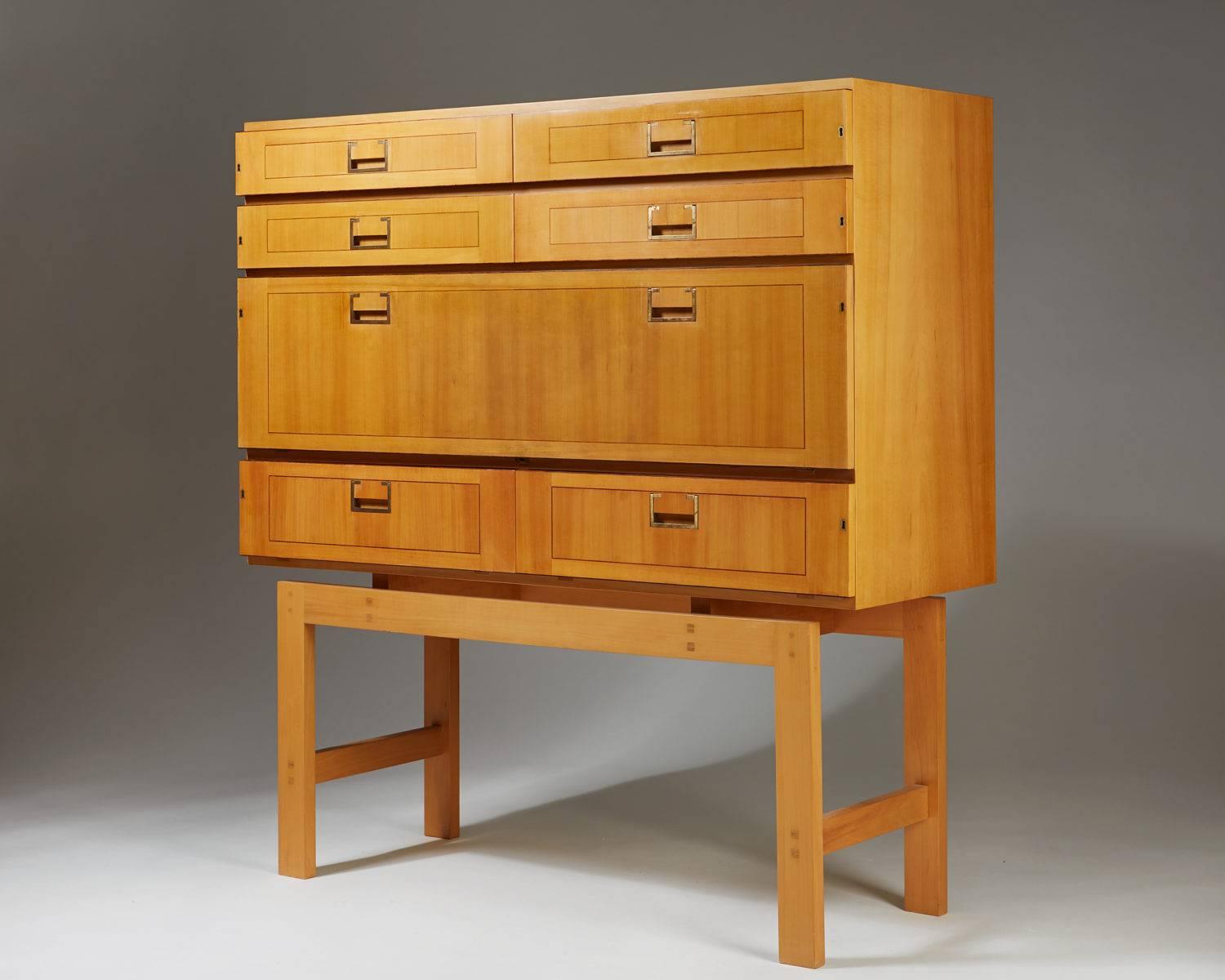 Cabinet on stand, anonymous,
Sweden, 1950s.

Cherry and rosewood details.
  