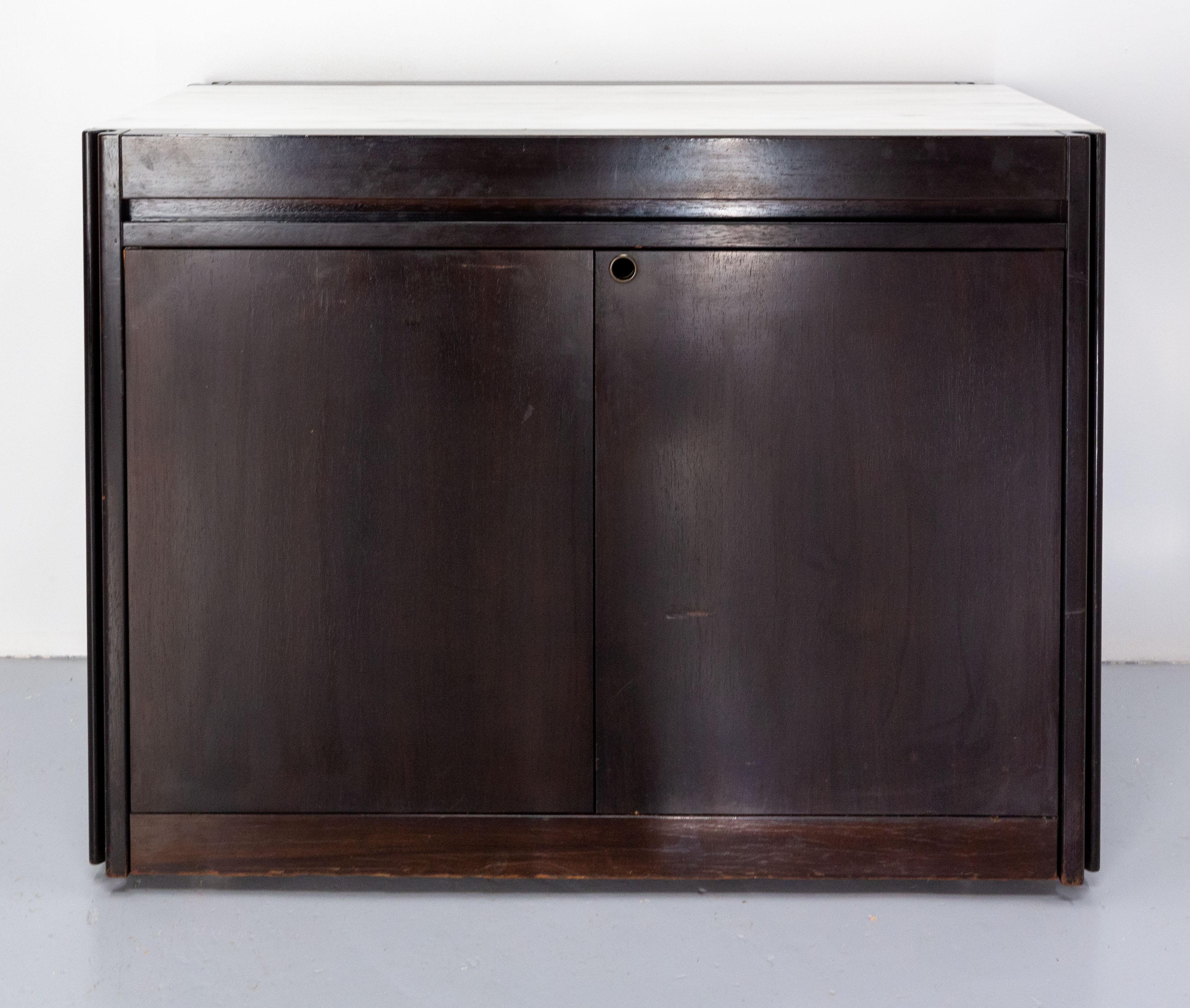 Rare and surprising, this cabinet is transformable into a large dining table, saving space for small rooms.
The doors are a little bit difficult to shut, and they have no more lock.
Easy to move this furniture is on wheels.
Solid exotic wood,