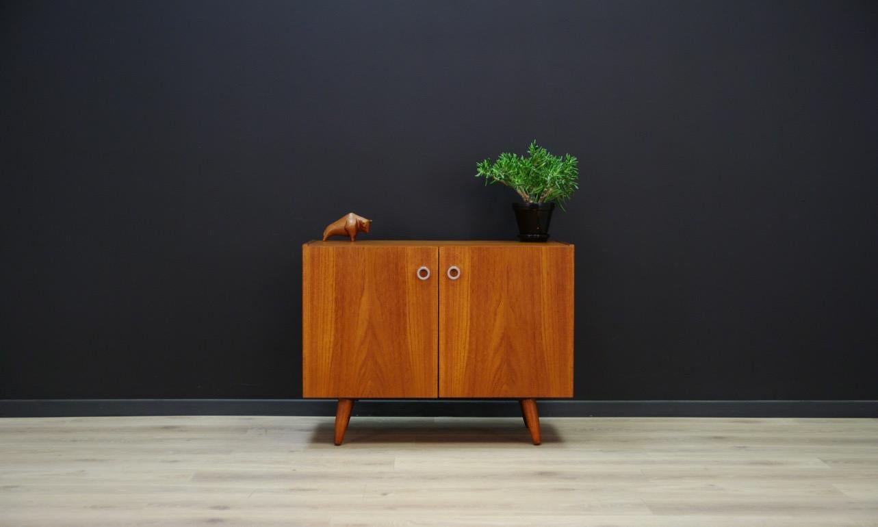 Original cabinet from the 1960s-1970s, Danish design with unconventional front. Furniture veneered with teak. Unconventional handles. In the interior, there are shelves behind the doors. Preserved in good condition (small bruises and scratches) -