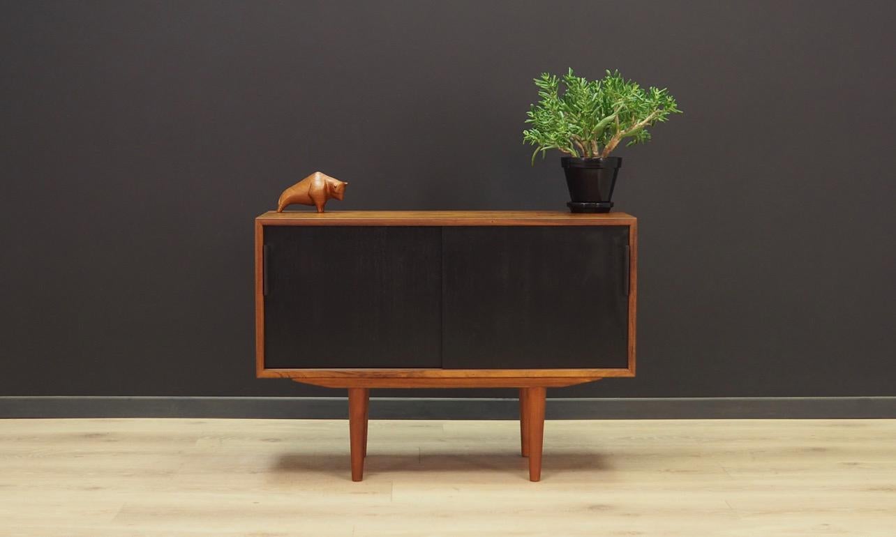 An excellent bookcase from the 1960s-1970s. Scandinavian style, designed by Extraordinary chest of drawers from the 1960s-1970s, Danish design, minimalistic form. Furniture covered with rosewood veneer. Shelf behind a sliding, black door. Maintained