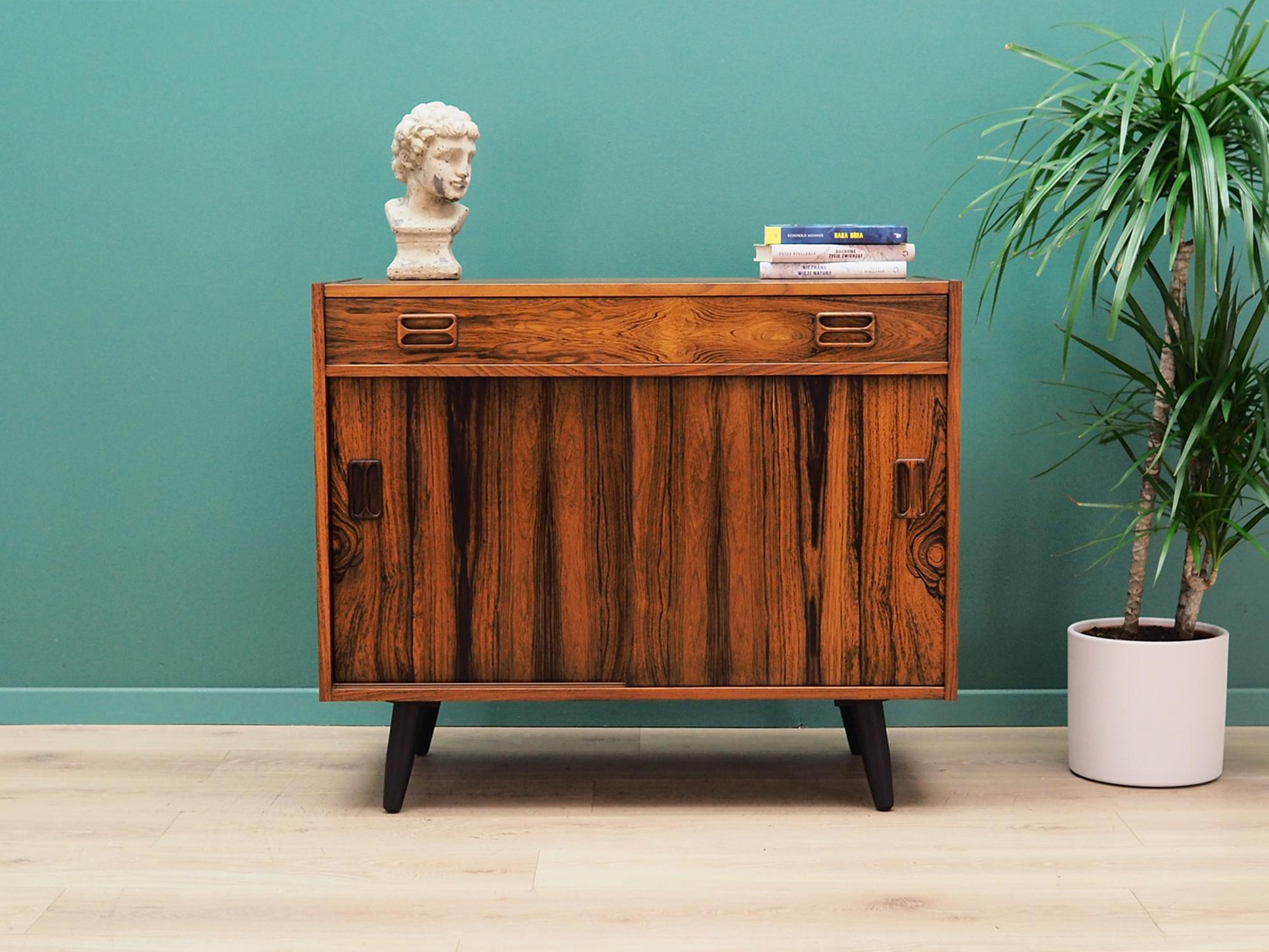Cabinet was made in the 1970s, designed by well-known Danish designer Niels J. Thørso.

The structure is covered with rosewood veneer. The legs are made of solid wood stained black. Surface after refreshing. Inside the space has been filled with a