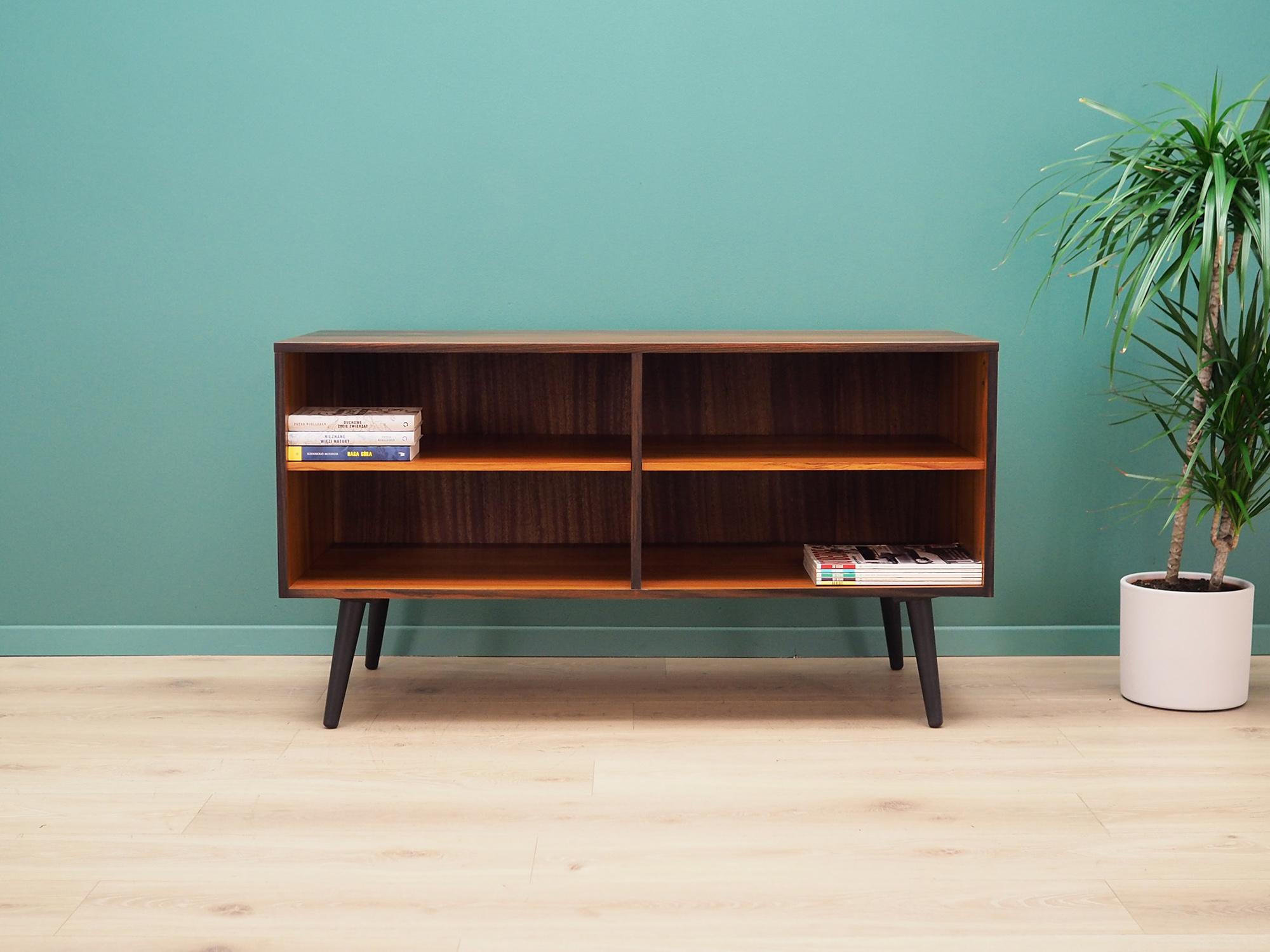 Cabinet was made in the 1960s, Danish production.

The construction is covered with rosewood veneer. Legs made of solid wood stained black. The surface after refreshing. Inside the space has been filled with practical shelves with adjustable