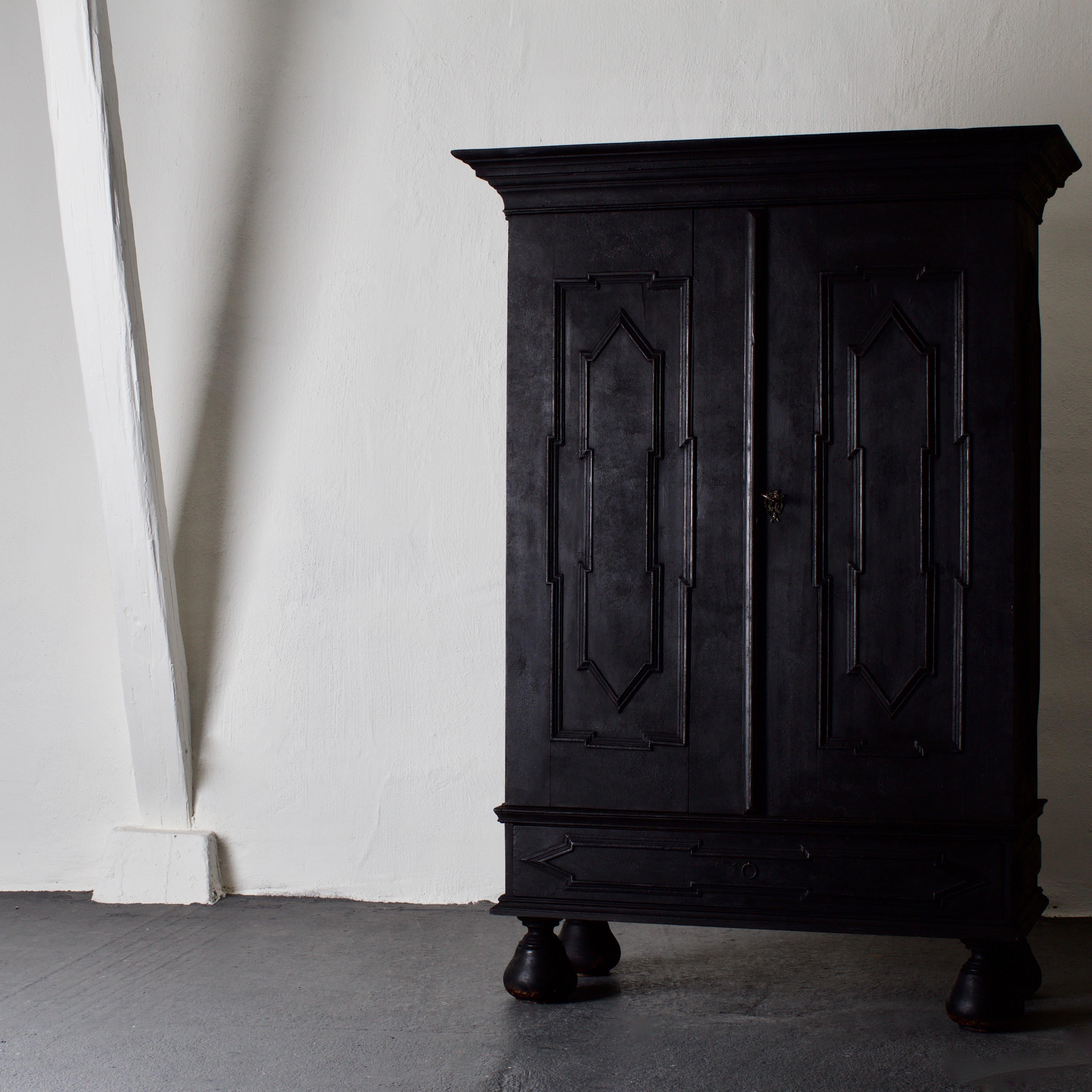A cabinet made in the Baroque style 19th century in Sweden. Painted in our Laserow black. Interior with shelves and spoon hanging shelves. Standing on ball feet.


 
 