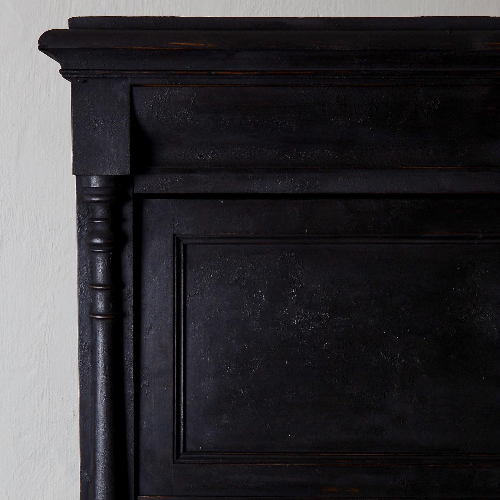 A cabinet made during the 19th century in Sweden. Repainted in our Laserow Black. Contemporary hardware. Interior behind cabinet door with two shelves and a drawer at bottom.

 