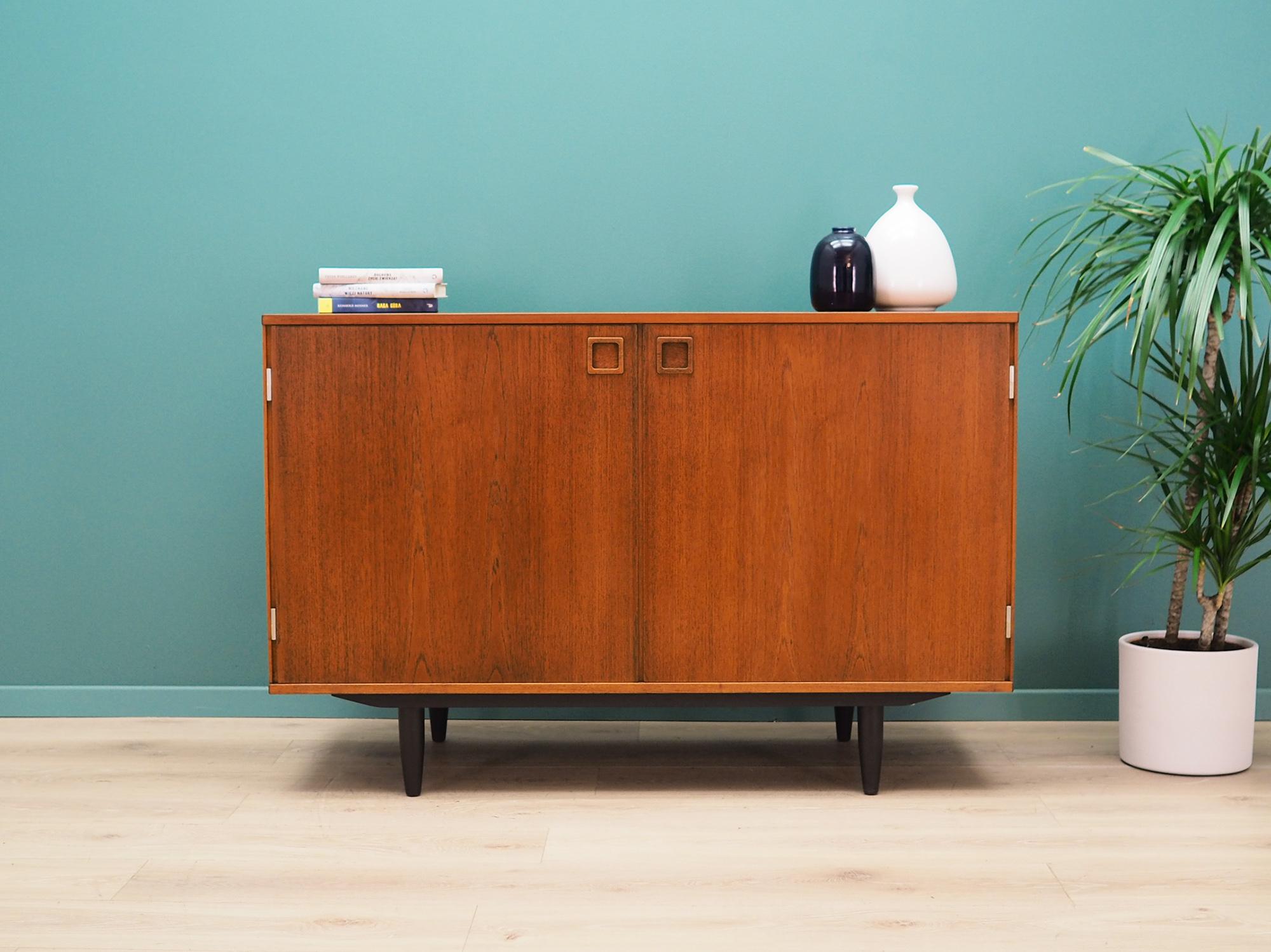Cabinet was made in the 1960s, designed by an icon of Danish design Peter Løvig Nielsen.

The construction is covered with teak veneer. The legs are made of solid wood and stained black. Surface after refreshing. Inside, the space has been filled