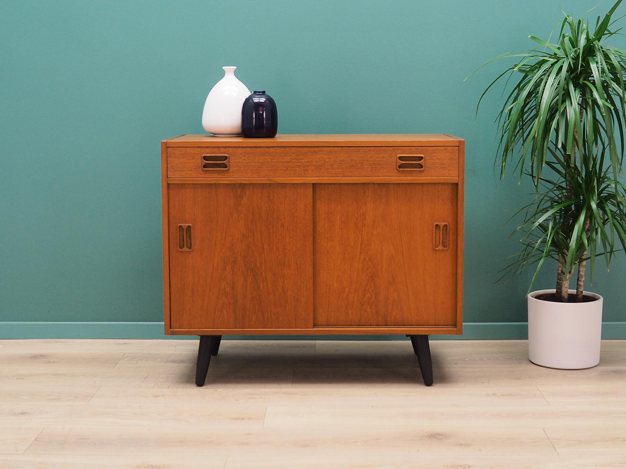 Cabinet was made in the 1970s, it was designed by the Danish design icon Emil Clausen.

The construction is covered with teak veneer. Legs made of solid wood stained black. The surface after refreshing. Inside the space has been filled with a