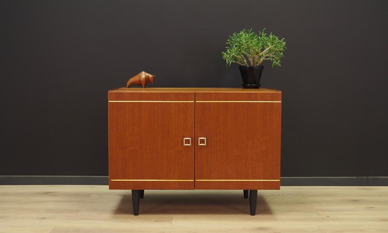 Phenomenal cabinet from 1960s-1970s, Danish design, Minimalist form. The furniture finished with teak veneer. Shelf in the interior. Maintained in good condition (minor bruises and scratches) - directly for use.

Dimensions: Height 66 cm, width