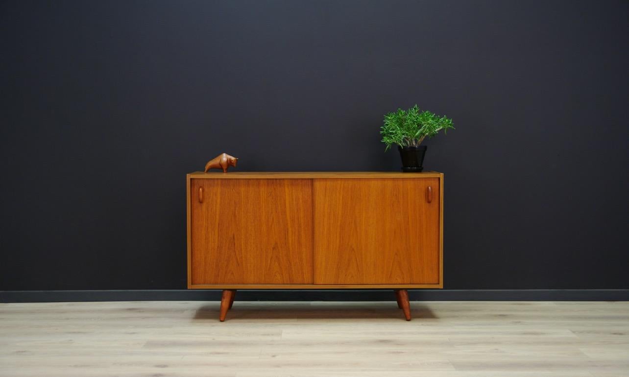 Original 1960s-1970s cabinet - Danish design. Furniture veneered with teak. Inside, behind sliding doors there are shelves. Preserved in good condition (small bruises and scratches) - directly for use.

Dimensions: Height 70.5 cm, Width 120 cm,
