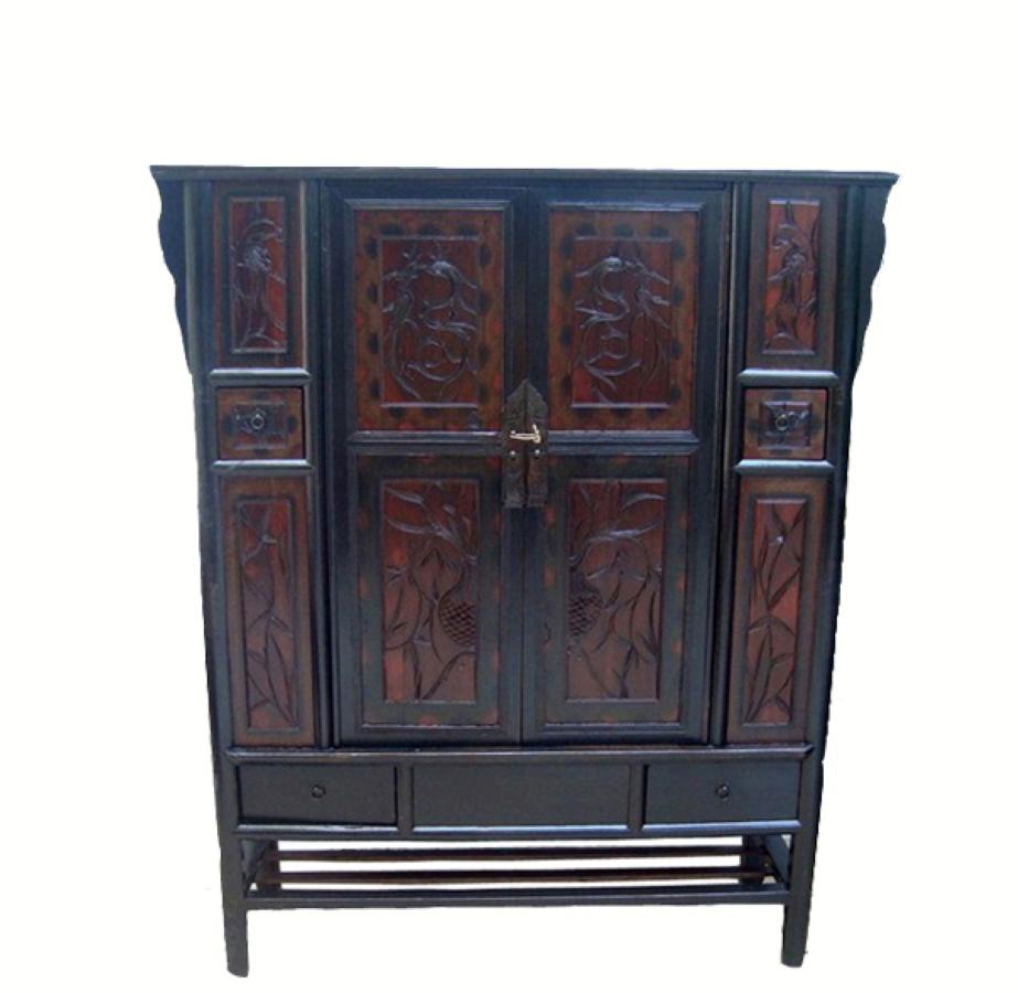 Featuring two intricately carved panel doors and four rectangular panels on each side, this antique Chinese cabinet adds an Asian aesthetic appeal to a great room, living room, dining room or bedroom. It has one small drawer on each side and two
