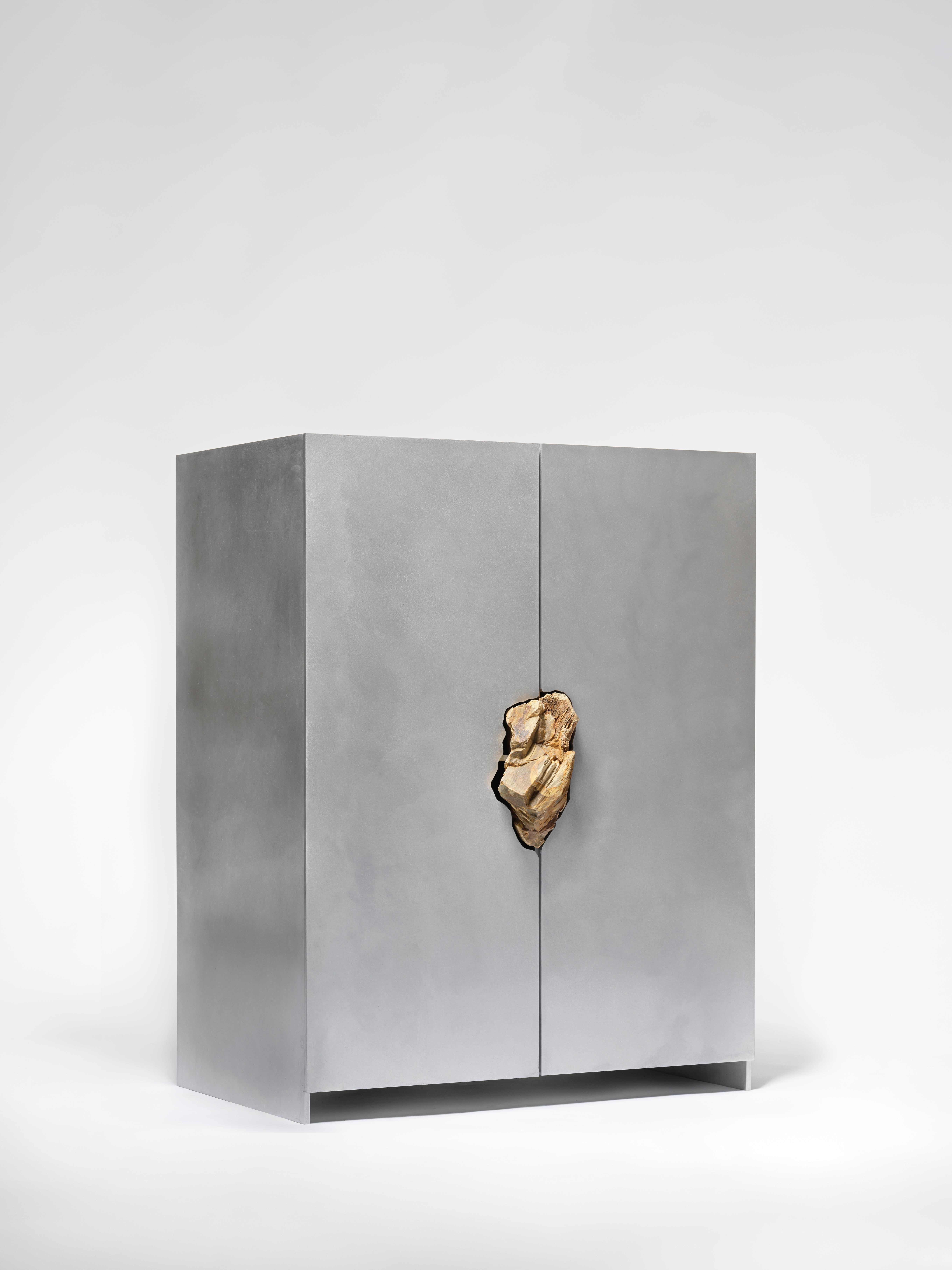 Cabinet with Petrified oak by Pierre De Valck.
Dimensions: W 70 x D 45 x H 96 cm.
Materials: Waxed aluminium with petrified oak
Weight: 65 kg.
Each piece is unique.

Pierre De Valck (1991) born in Brussels, is a Ghent-based designer with a