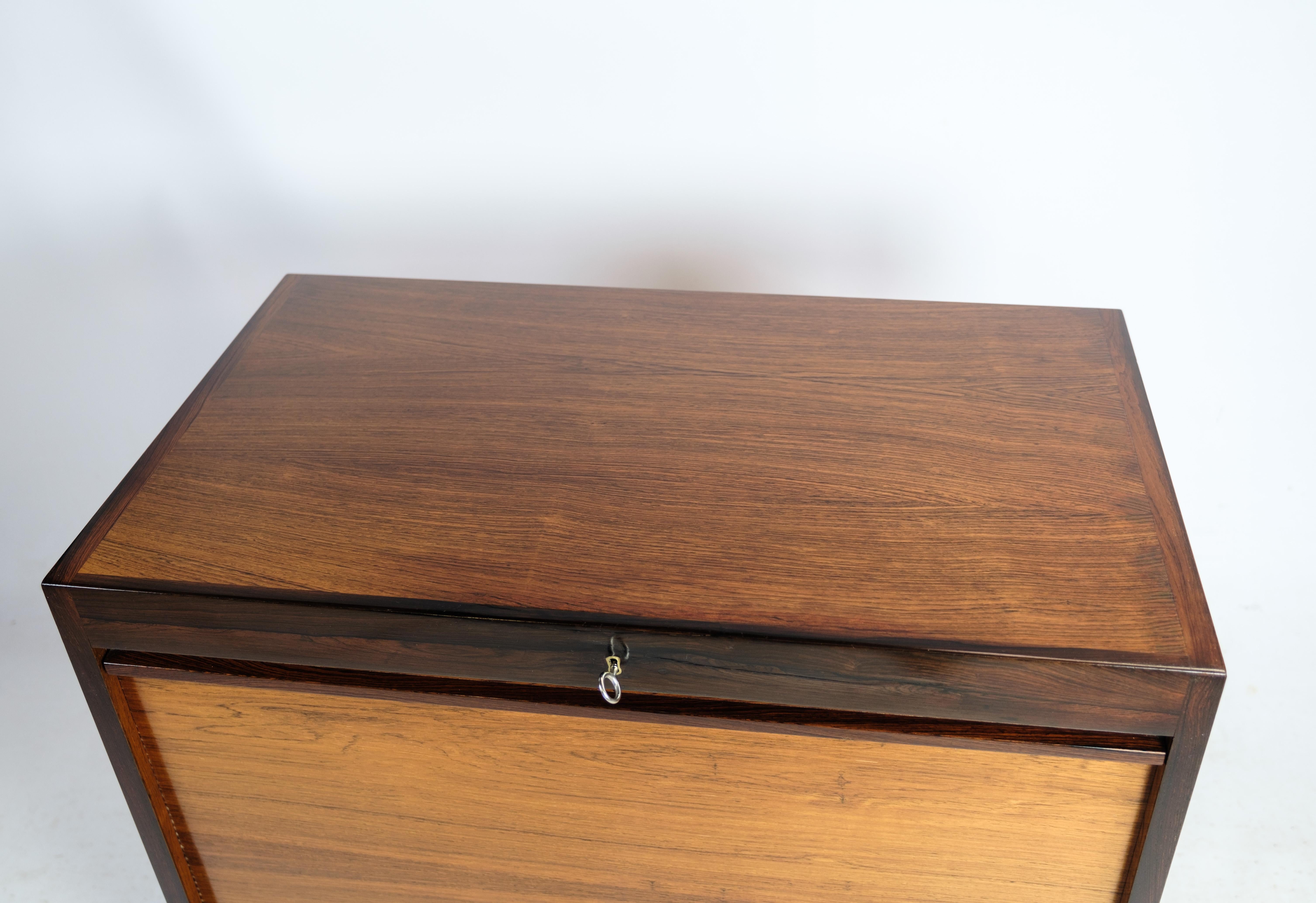 Cabinet with pull-up door in rosewood of danish design from the 1960s. The cabinet is in great vintage condition.

This product will be inspected thoroughly at our professional workshop by our educated employees, who assure the product quality.
 