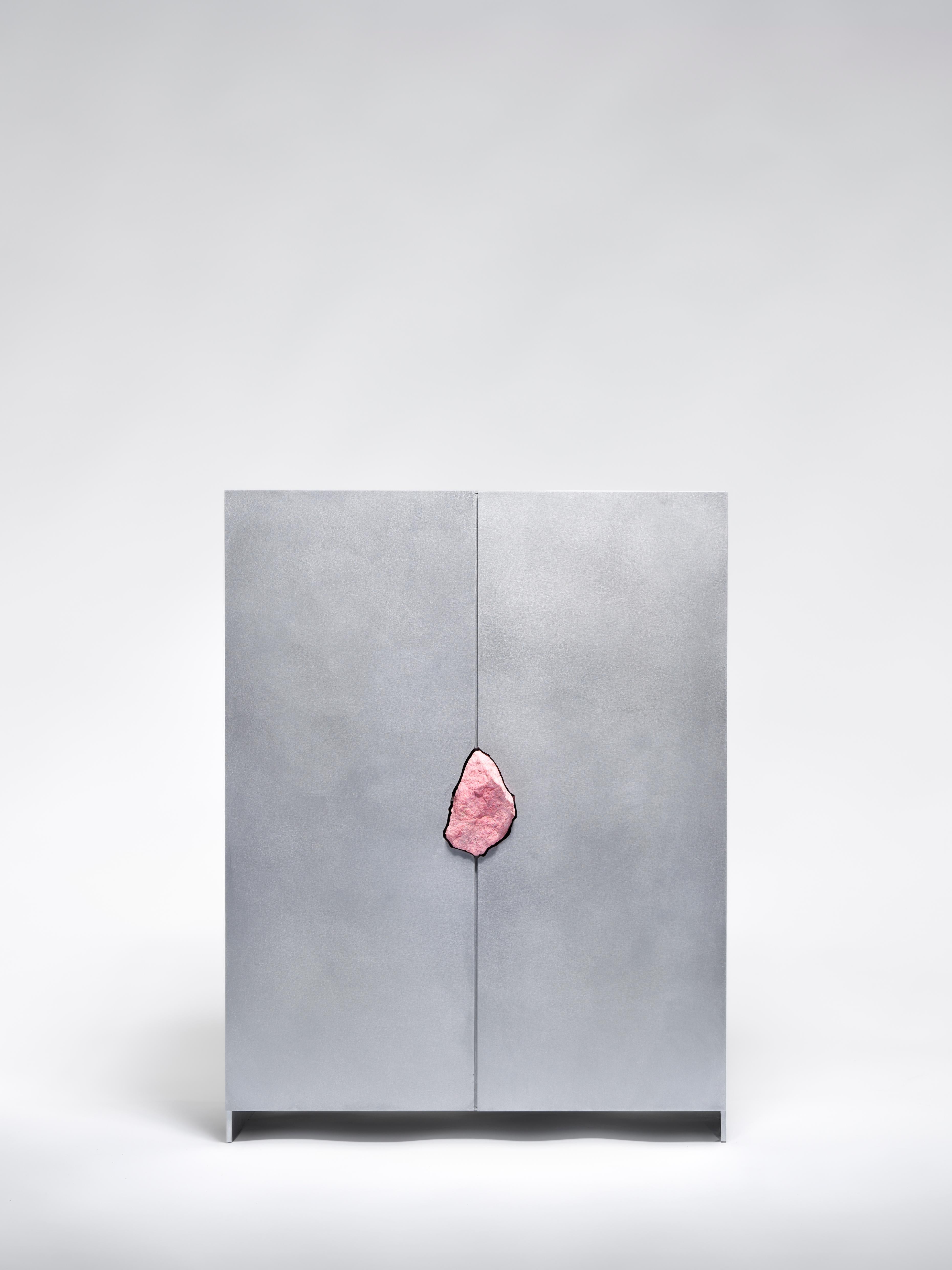 Cabinet with Thulite by Pierre De Valck.
Dimensions: W 55 x D 34 x H 70 cm.
Materials: Waxed aluminum with petrified oak
Weight: 65 kg.
Each piece is unique.

Pierre De Valck (1991) born in Brussels, is a Ghent-based designer with a childhood