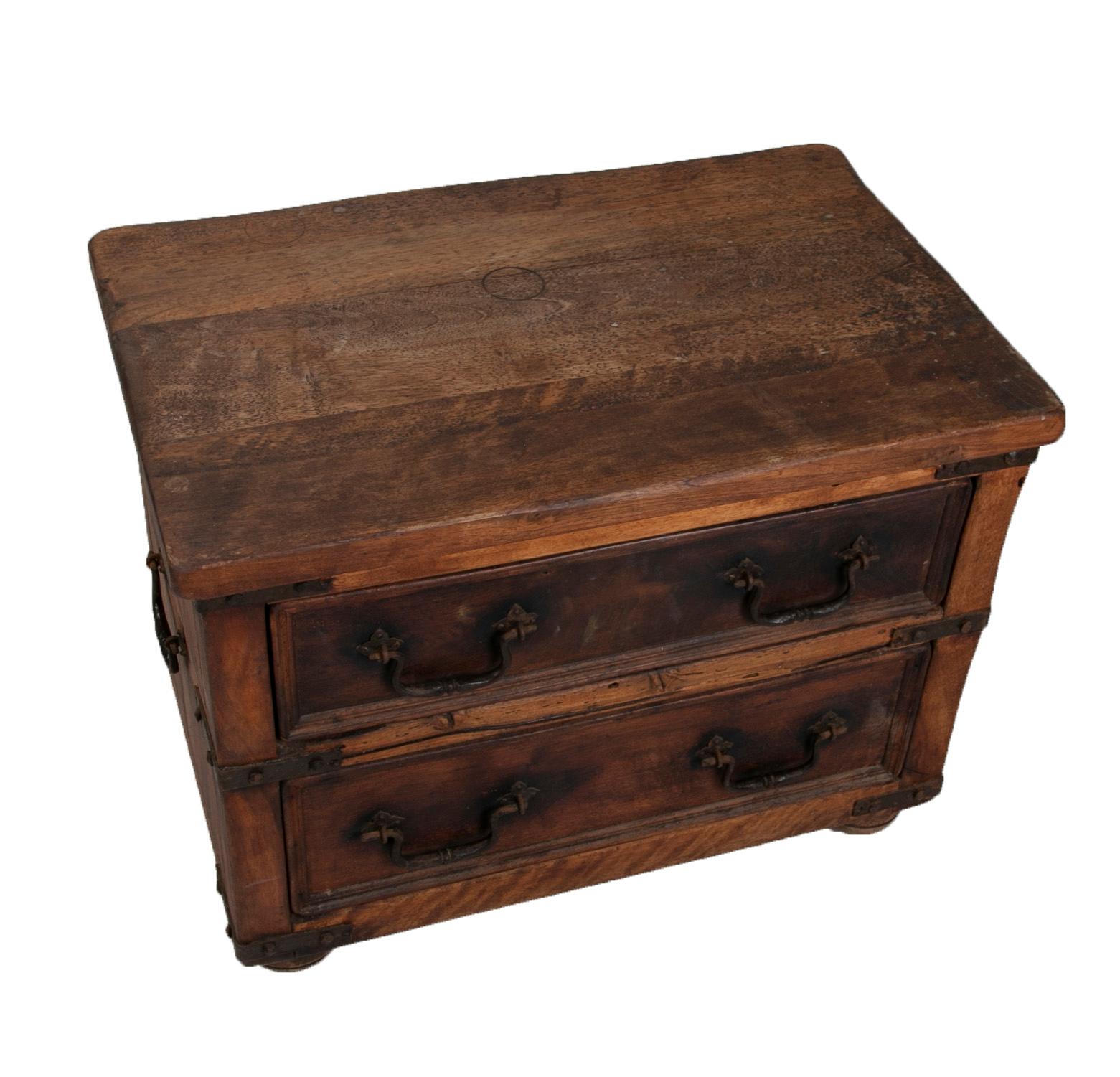 Cabinet with two wooden drawers with handles and iron reinforcements.