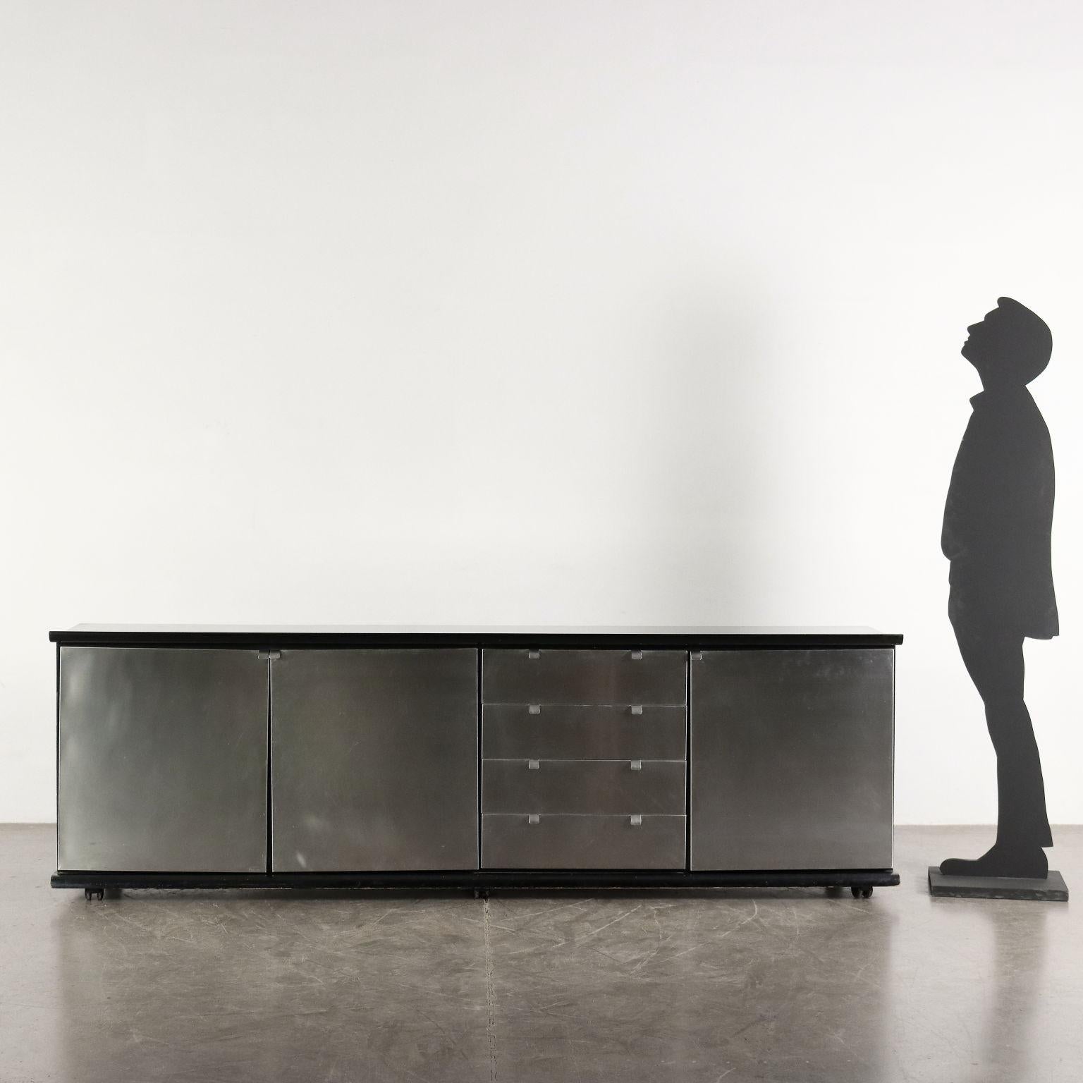 Cabinet with hinged doors and exposed drawers; lacquered wood and chromed aluminum coating.