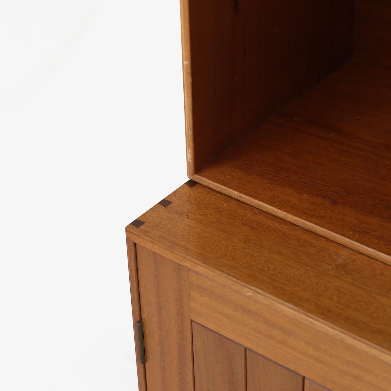 Cabinet by architect Mogens Koch for Rud. Rasmussen Snedkerier.
We can offer Mogens Koch's shelving system in customised quantities. Shown in the first picture are three cabinets, three pedestals and six bookcases in mahogany. The price is for one