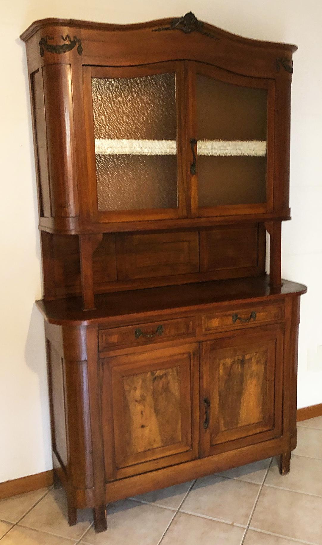 Cabinets Italian showcase in national walnut in natural color art deco style 2.
The piece of furniture is divided into two parts, the upper one with two glass and the lower one with drawers and doors with internal shelf.
Original handles. 
All