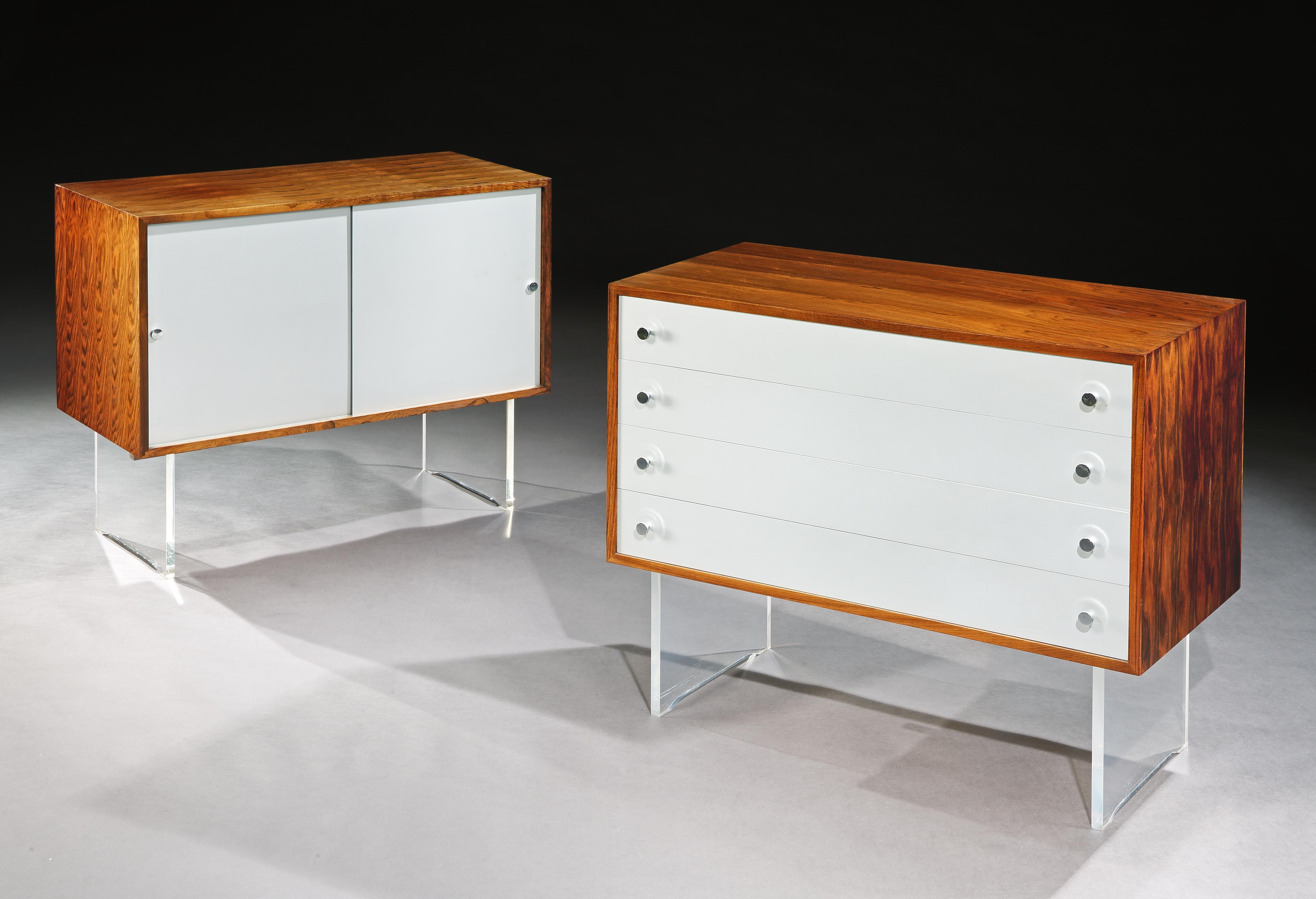 This pair of cabinets is characteristic of  Poul Nørreklit.   The combination of aluminium and plexiglass with beautifully figured Brazilian rosewood veneers creates signature pieces for the home.   The fusion of different materials blends different