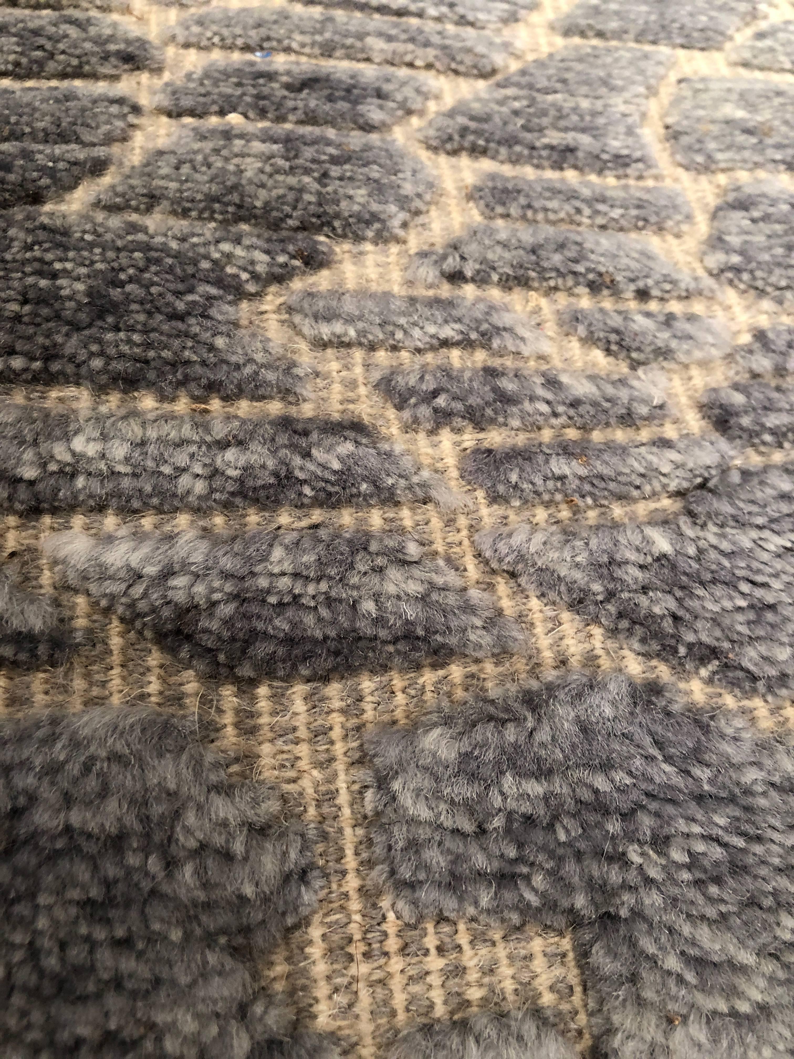 The reverse tufting of this deep blue rug creates wonderful texture for any room. The irregular patterns made by the flat-weave construction in between the hand-knotted tufting makes this a true beauty in both construction and usability in a room.