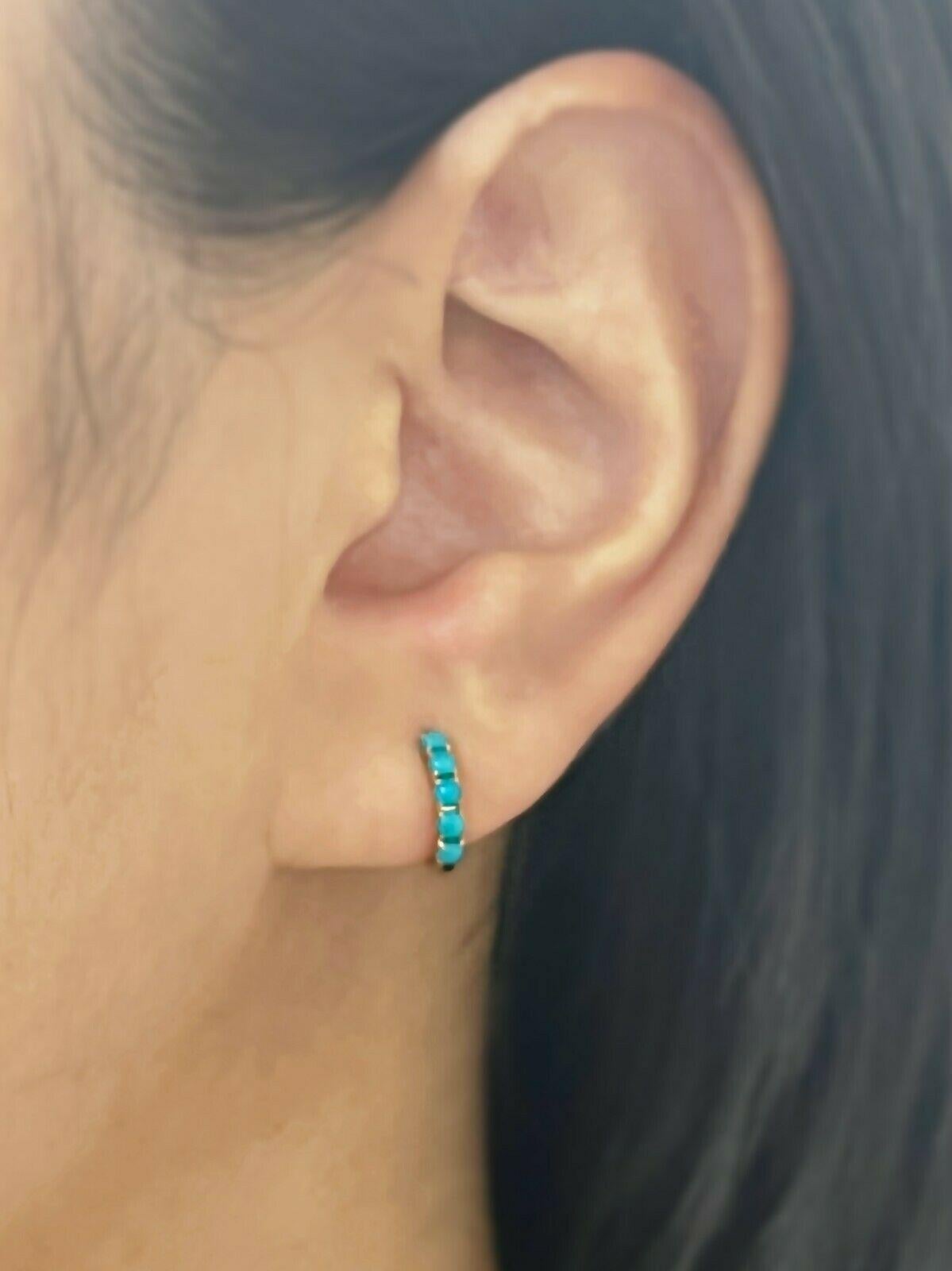 Cabochon Turquoise (0.43 total carat weight) huggie hoop earrings in 14k yellow gold. The earrings are designed and handmade locally in Los Angeles by Sage Designs L.A. Earrings are 0.4