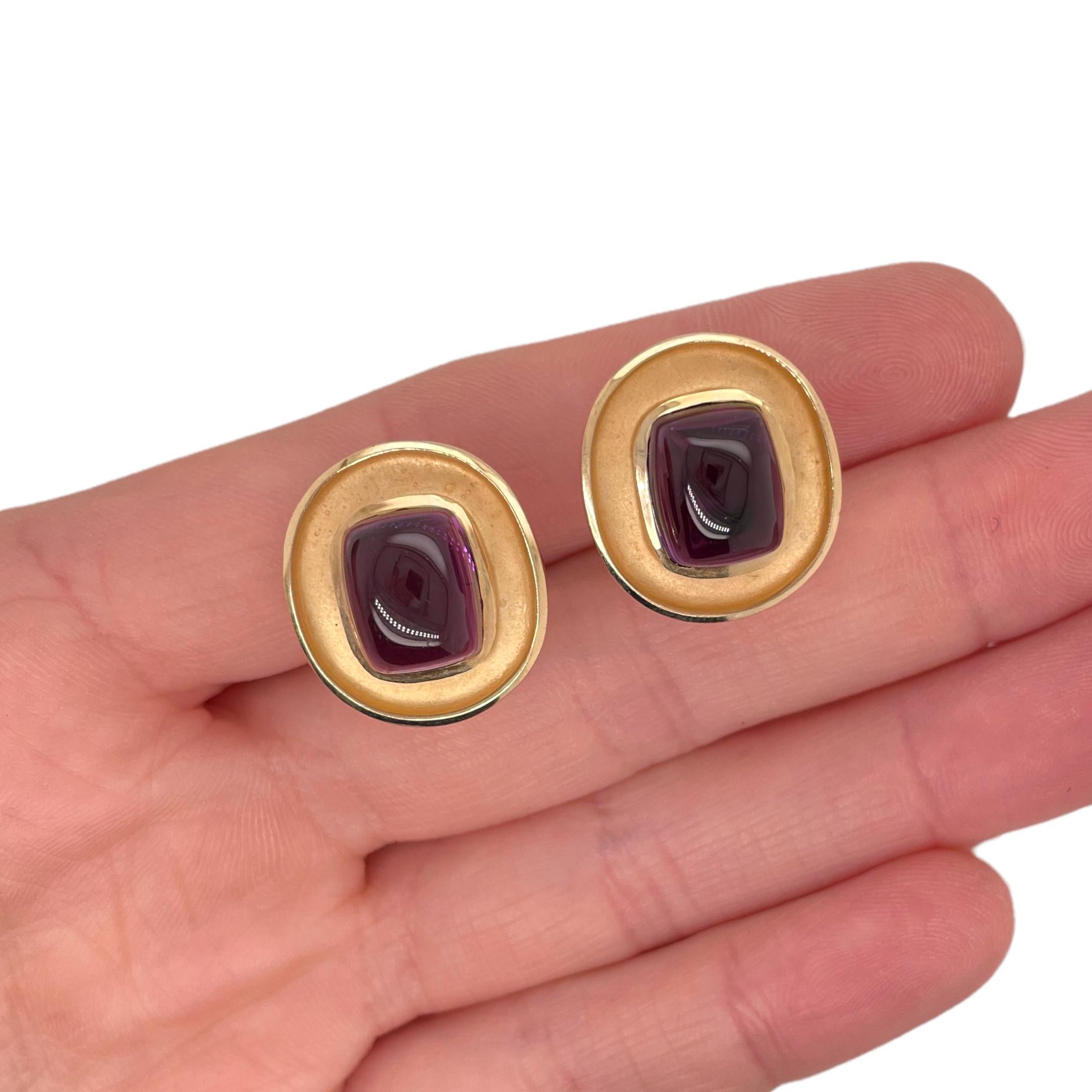 Amethyst clip earrings contain 2 finely matched square shape cabochon cut amethysts. 
Stones weigh approximately 5.00tcw and are set in bezel mountings. 
Earring weighs approximately 13.6grams and measure approximately 20x18mm.