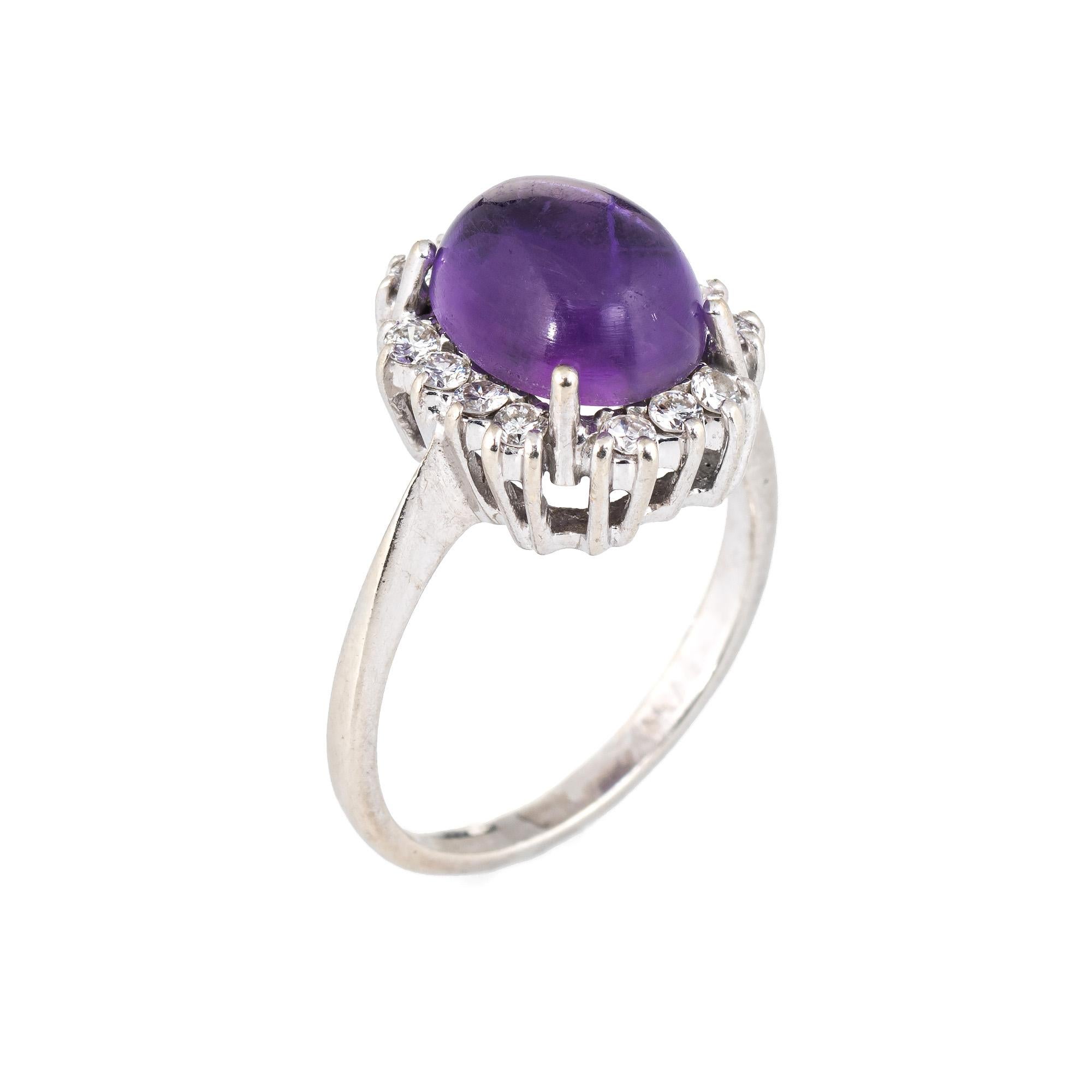 Elegant vintage amethyst & diamond ring (circa 1960s to 1970s), crafted in 14 karat white gold. 

Cabochon cut amethyst measures 10mm x 8mm (estimated at 4 carats), accented with 14 estimated 0.02 carat round brilliant cut diamonds. The total