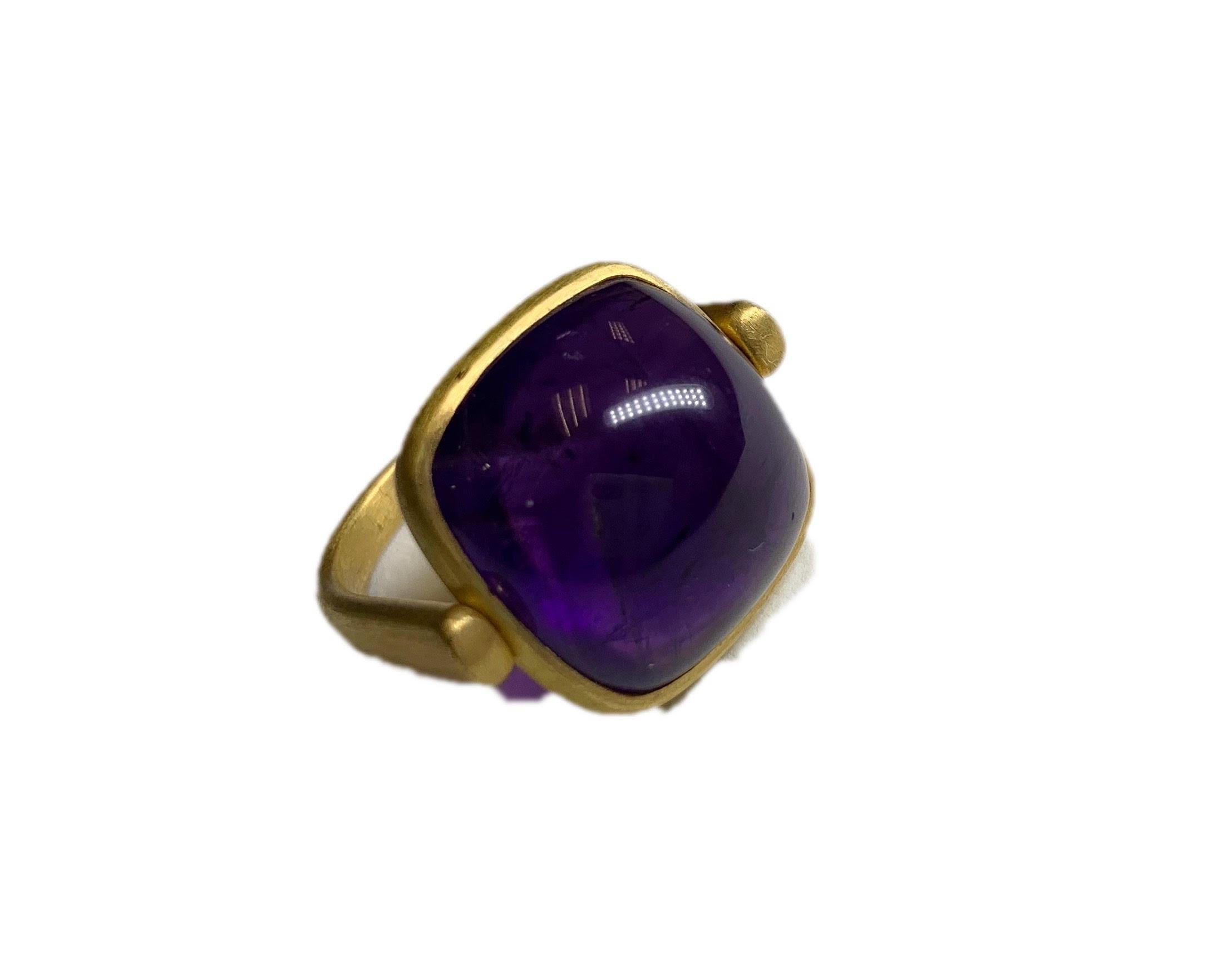 This playful cocktail ring features a 21.40 carat cabochon cut Amethyst. The center stone swivels independently from the rest of the ring as a design feature. The gold is 22 Karat Yellow Gold with a soft satin finish. 

A2 by Arunashi Amethyst Flip