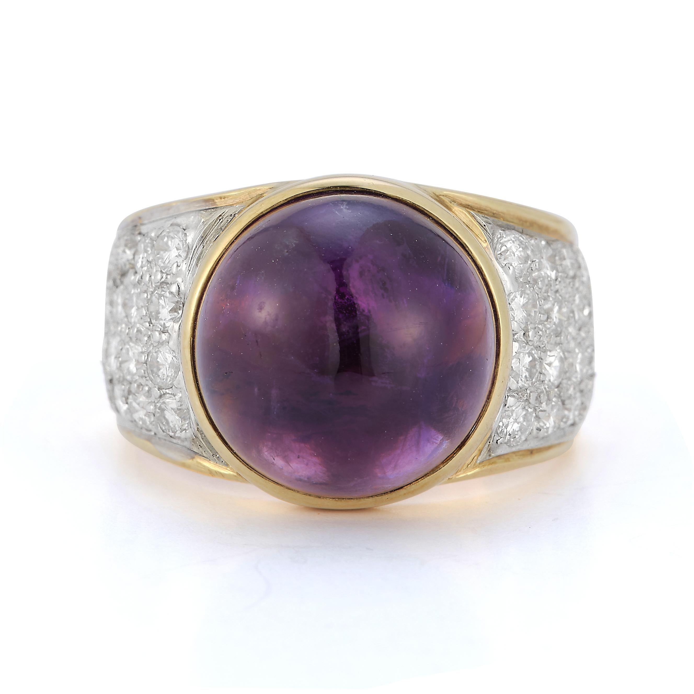 Cabochon Amethyst Ring gold ring with a central cabochon amethyst flanked and accented by 32 round diamonds

Cabochon Amethyst approximate weight: 9.75ct

Diamonds total approximate weight: 1.22ct

14 karat gold

Ring size: 7.5
Resizable free of