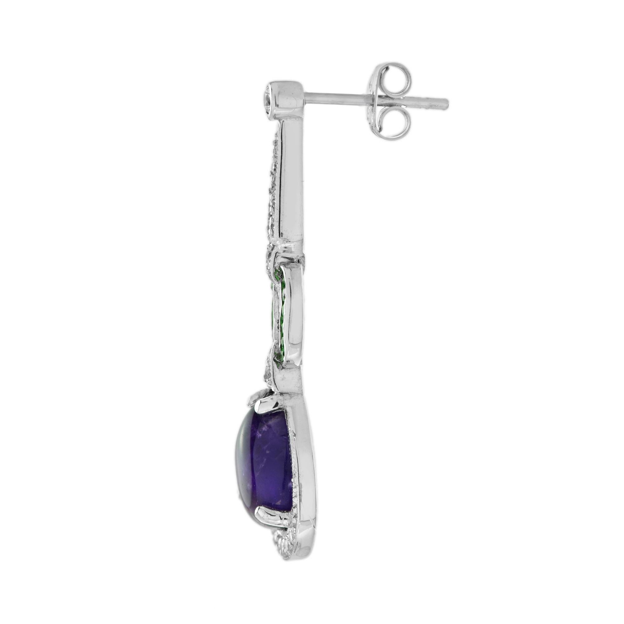 Impressive vintage inspired white gold dangle earrings mounted with cabochon amethysts, emeralds, and round cut diamonds. 

Earrings Information
Style: Art Deco
Metal: 14K White Gold
Width: 10 mm.
Length: 35 mm.
Total weight: 5.53 g. (approx. total
