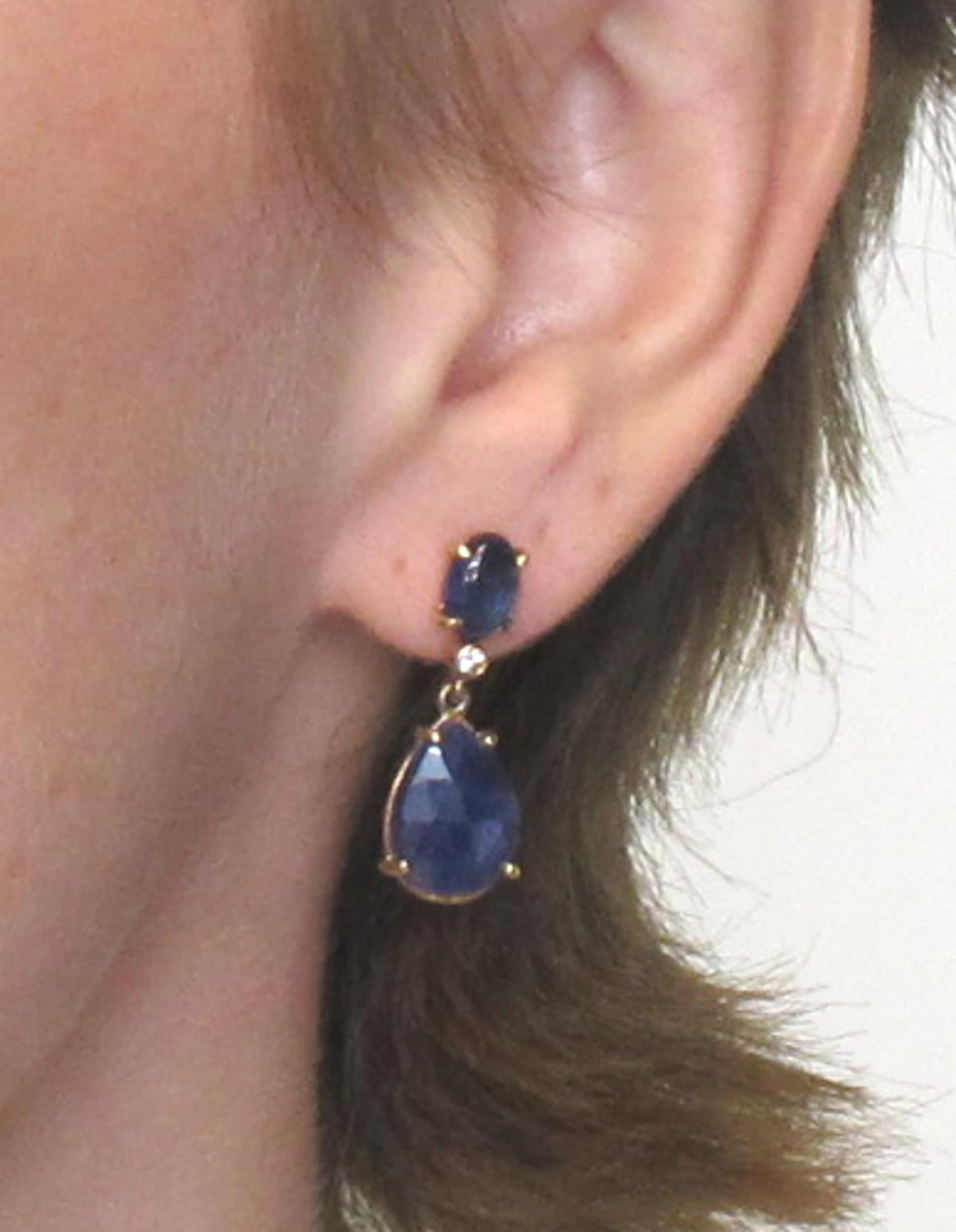 Denim blue cabochon cut and  rose cut sapphires weighing  10.14 carats total are set with round brilliant cut diamonds weighing  0.10 carats total in these beautiful earrings. They are unusual and suitable for everyday wear but could be dressed up