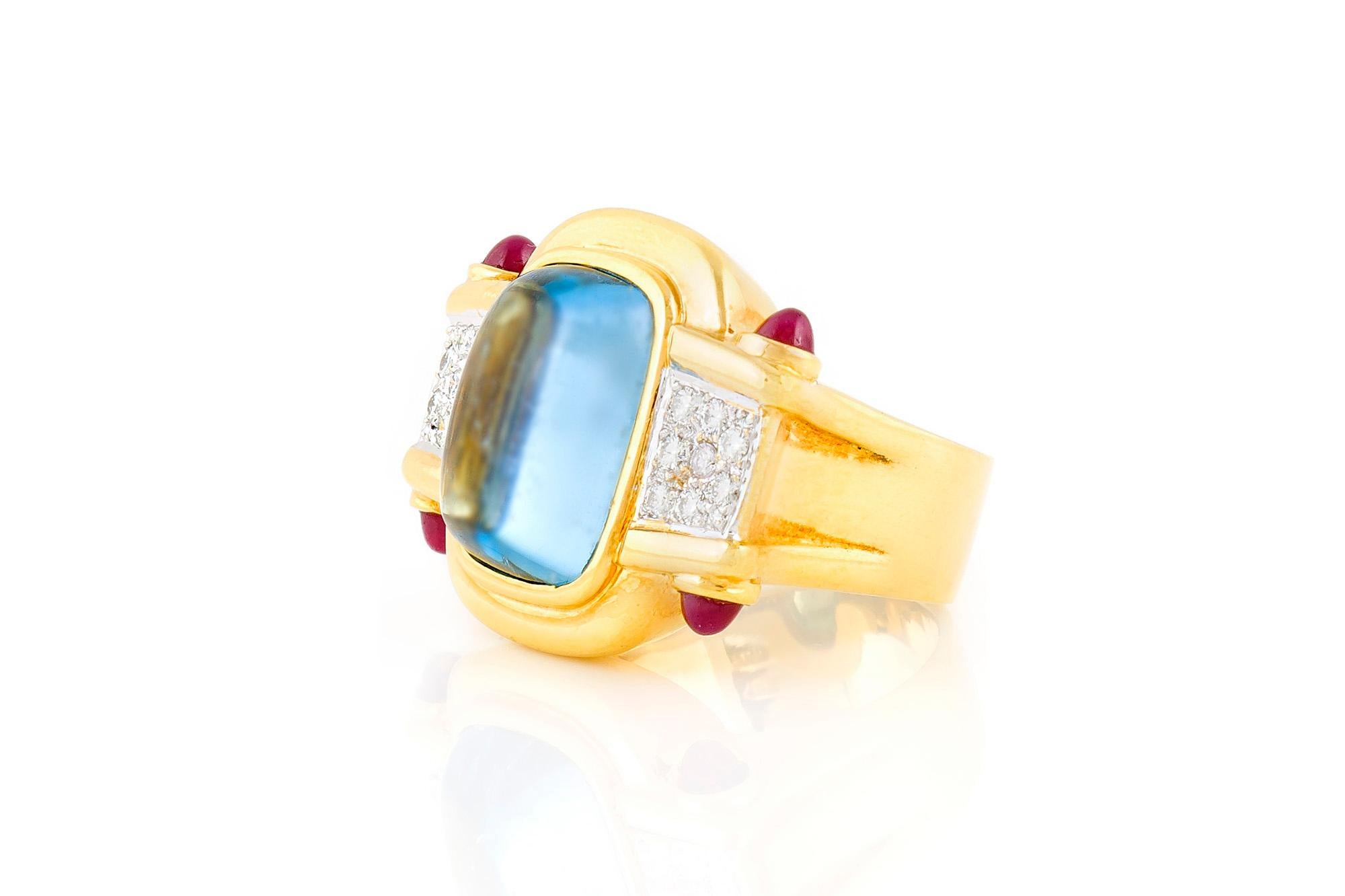 Ring, finely crafted in 18k yellow gold with an aquamarine center stone weighting approximately a total of 8.00 carats, diamonds on sides weighting a total of 0.40 carats and rubies weighting a total of 0.50 carats. Circa 1990's.