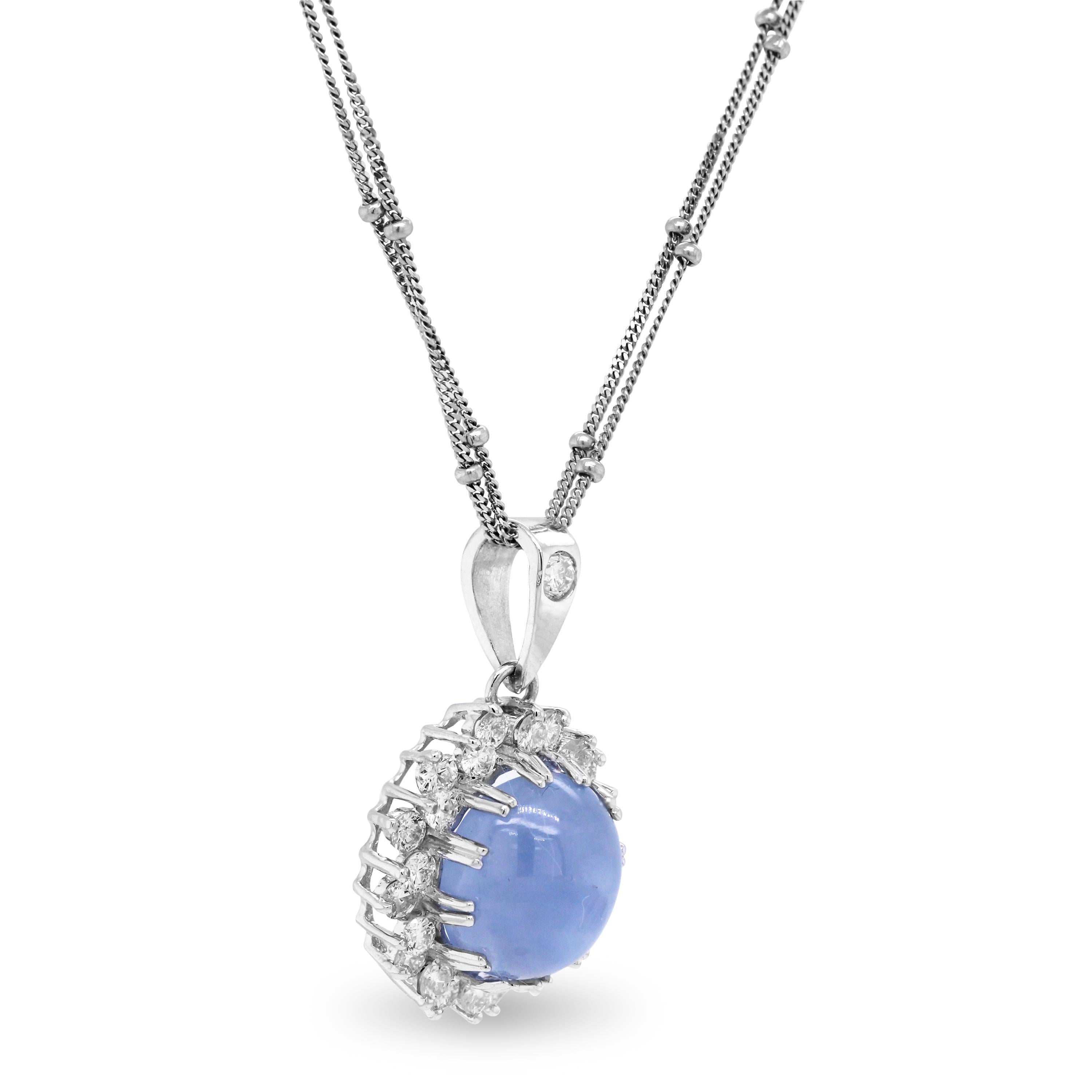 Cabochon Blue Sapphire and Diamond 18K White Gold Pendant with Double Link Chain

This beautiful Blue Sapphire center is a Cabochon-cut, oval with diamonds surrounding the center stone all around. 

1.40 carat Cabochon Blue Sapphire center
1.36