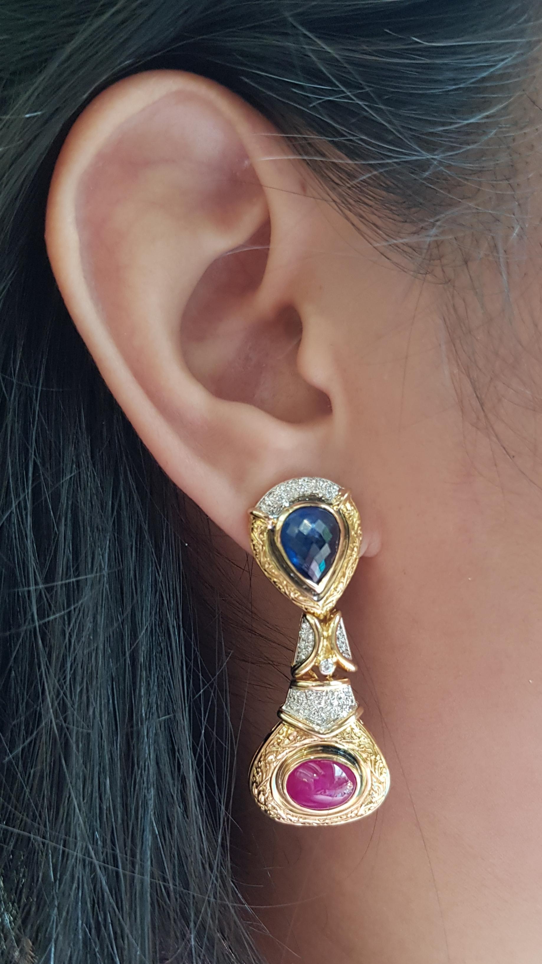 Cabochon Blue Sapphire 6.55 carats, Cabochon Ruby 6.74 carats with Diamond 0.40 carat Earrings set in 18 Karat Gold Settings

Width:  2.0 cm 
Length: 4.5 cm
Total Weight: 26.36 grams

