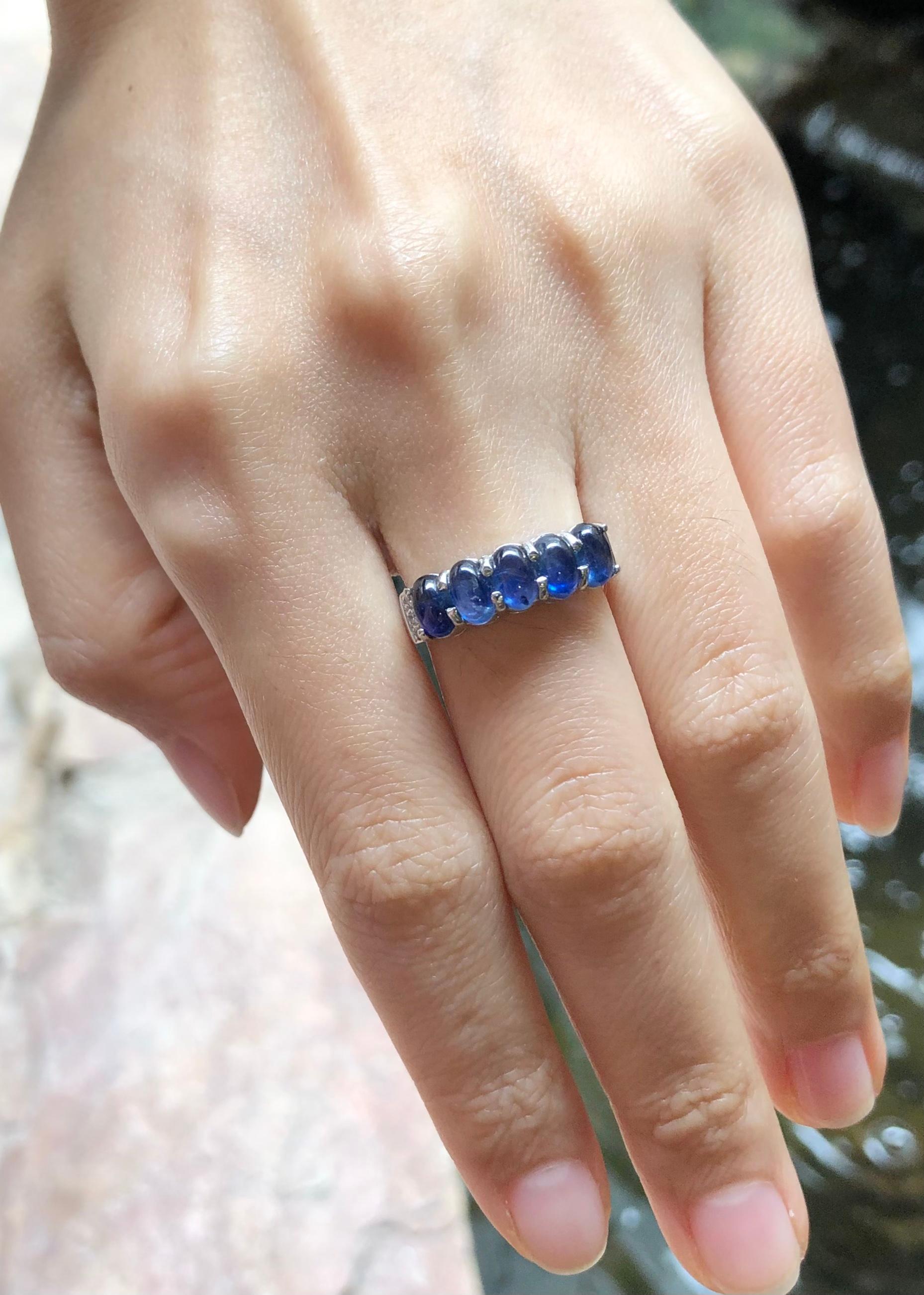Cabochon Blue Sapphire with Cubic Zirconia Ring set in Silver Settings

Width:  1.8 cm 
Length: 0.6 cm
Ring Size: 52
Total Weight: 3.6 grams

*Please note that the silver setting is plated with rhodium to promote shine and help prevent oxidation. 