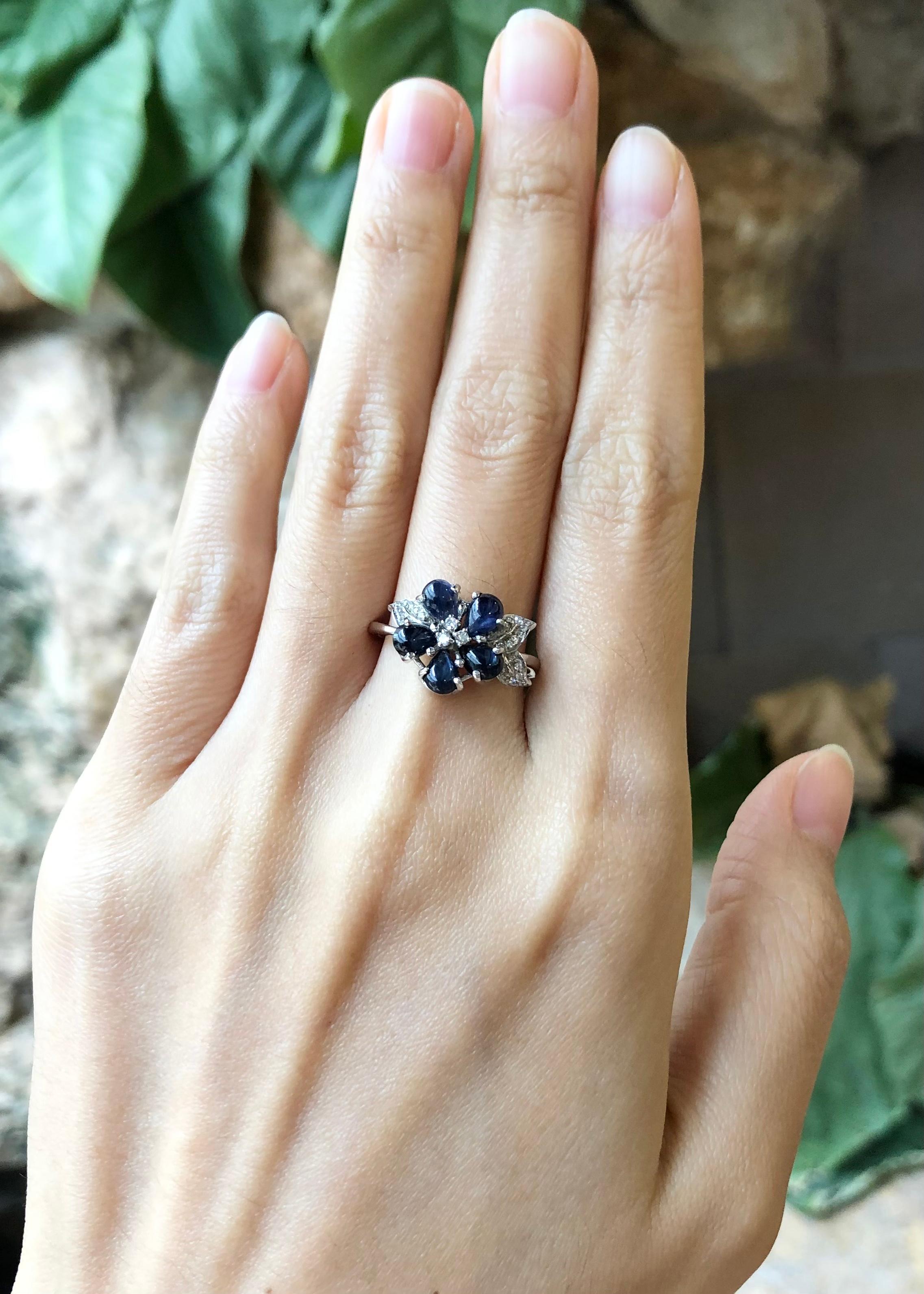 Cabochon Blue Sapphire with Cubic Zirconia Ring set in Silver Settings

Width:  1.2 cm 
Length: 1.2 cm
Ring Size: 56
Total Weight: 2.58 grams

*Please note that the silver setting is plated with rhodium to promote shine and help prevent oxidation. 