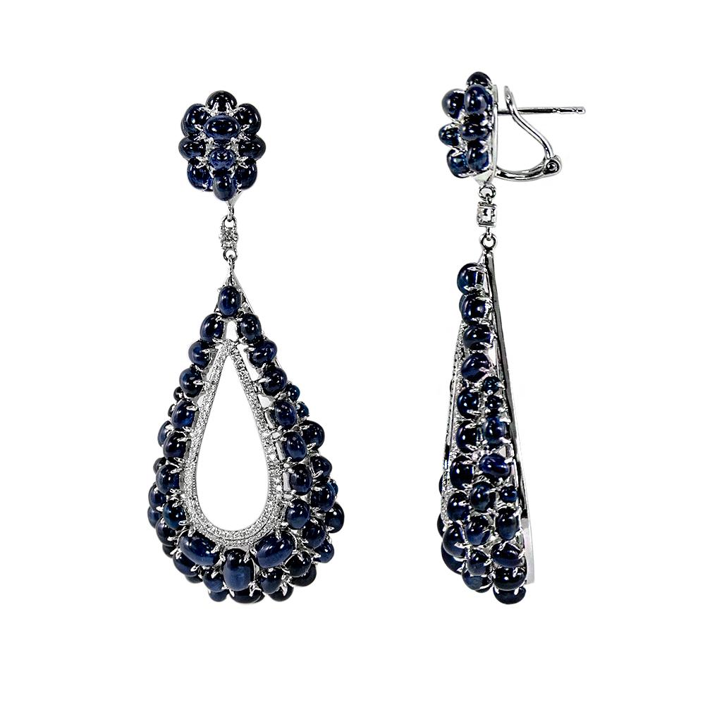Glamorous and charming pear shape dangle drop earrings hand crafted with assorted sizes of cabochon blue sapphires, total weight 37.25 carats, and accented with inner hoop of diamonds, total weight 0.80 carats, and for security and ease of use
