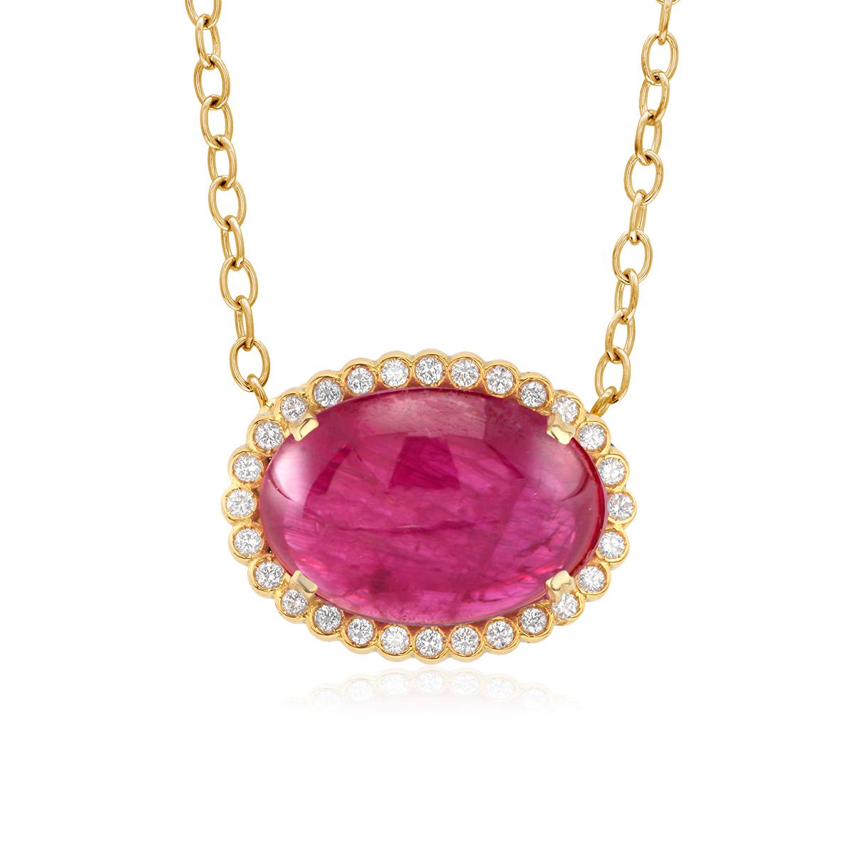 Eighteen karats yellow gold trending layered necklace pendant
Cabochon Ruby and diamond halo charm 
Cabochon Burma ruby weighing 21.26 carats
Diamond weighing 0.55 carats
Ruby hue tone color is pinkish-red
Chain measuring 17 inches long
Charm